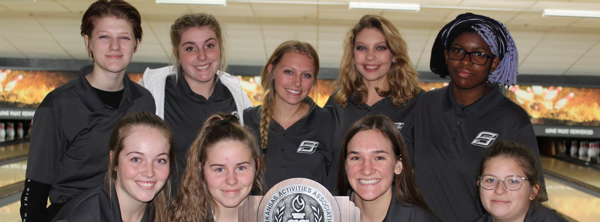 bowling team posing with trophy