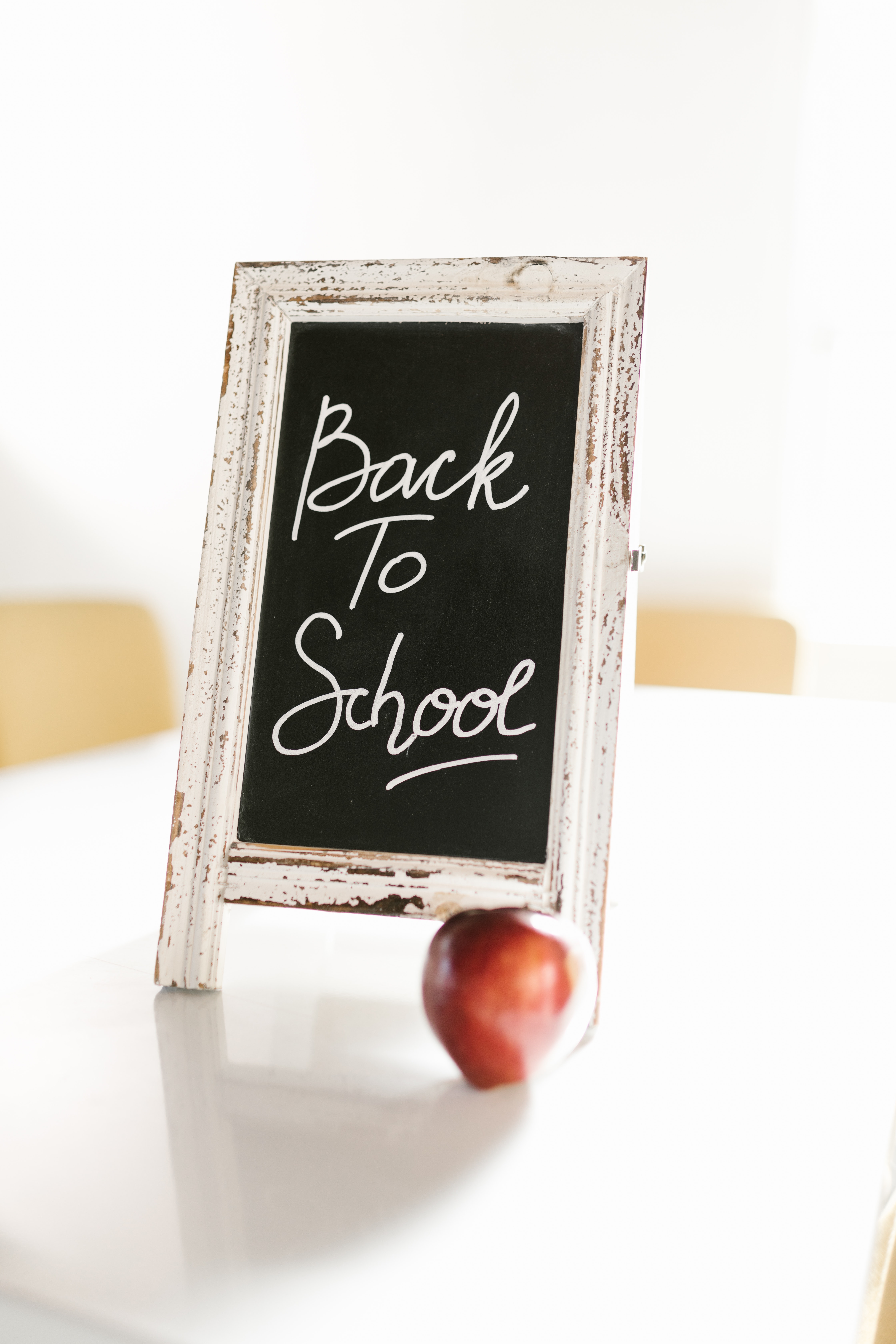 back to school written on a chalkboard with apple at base