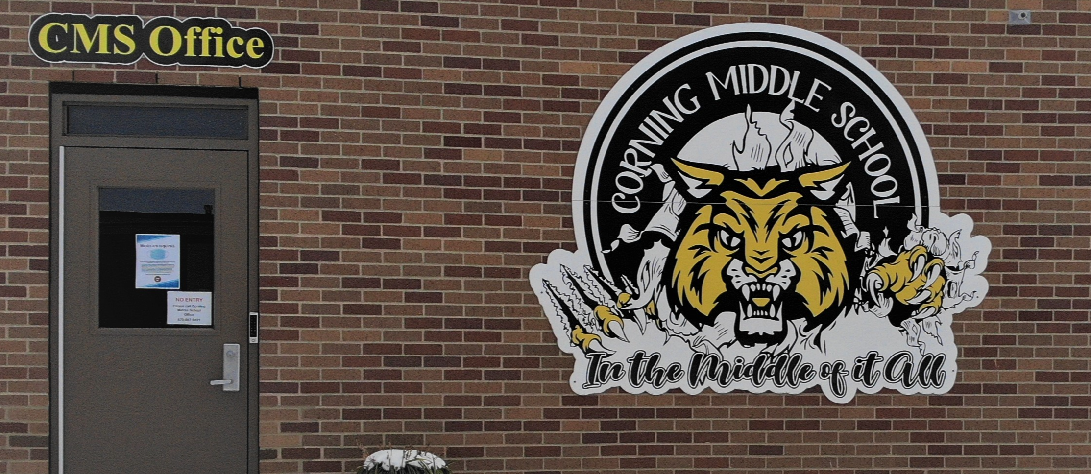 Corning Middle School in the middle of it all with yellow bobcat on side of brick building