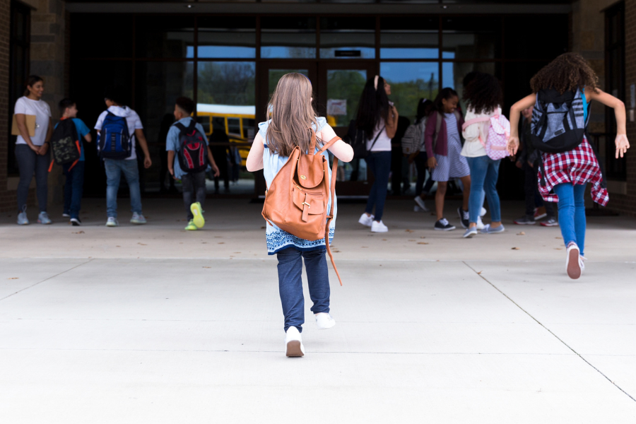 children running into a school