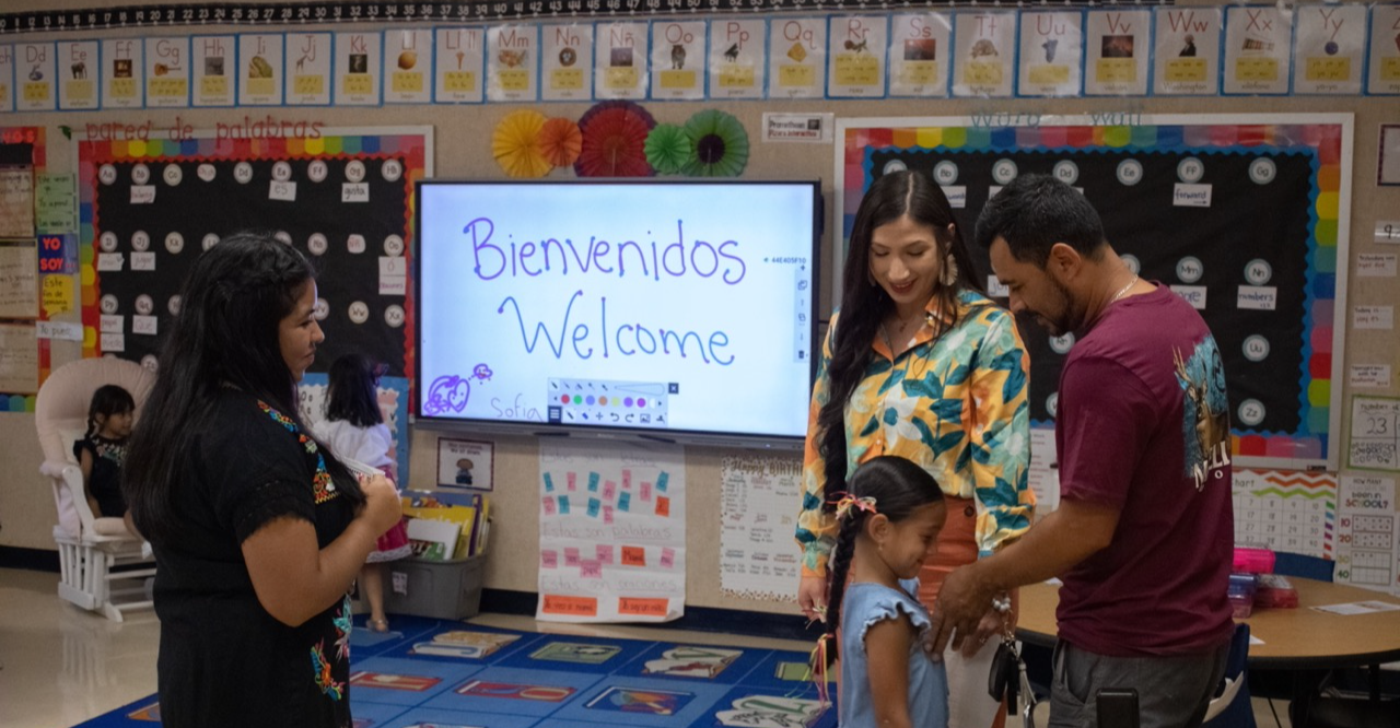 family walking into open house classroom