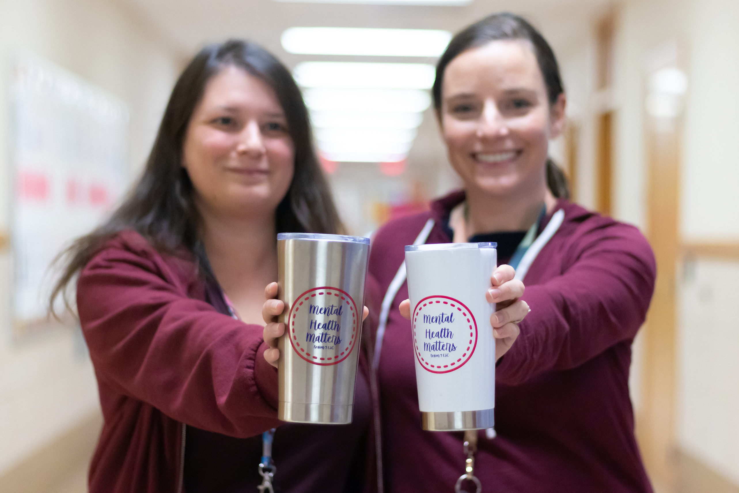 school counselor and mental health counselor holding coffe cups tumblers that say "mental health matters"