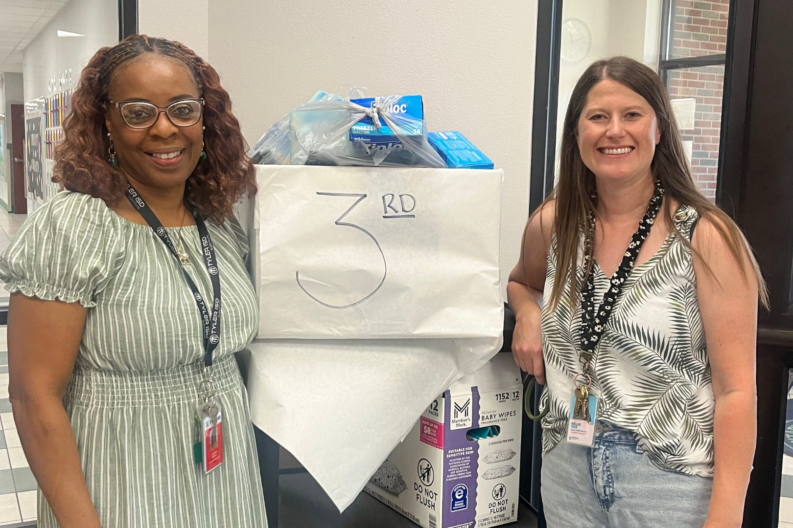 Two women with back to school supplies