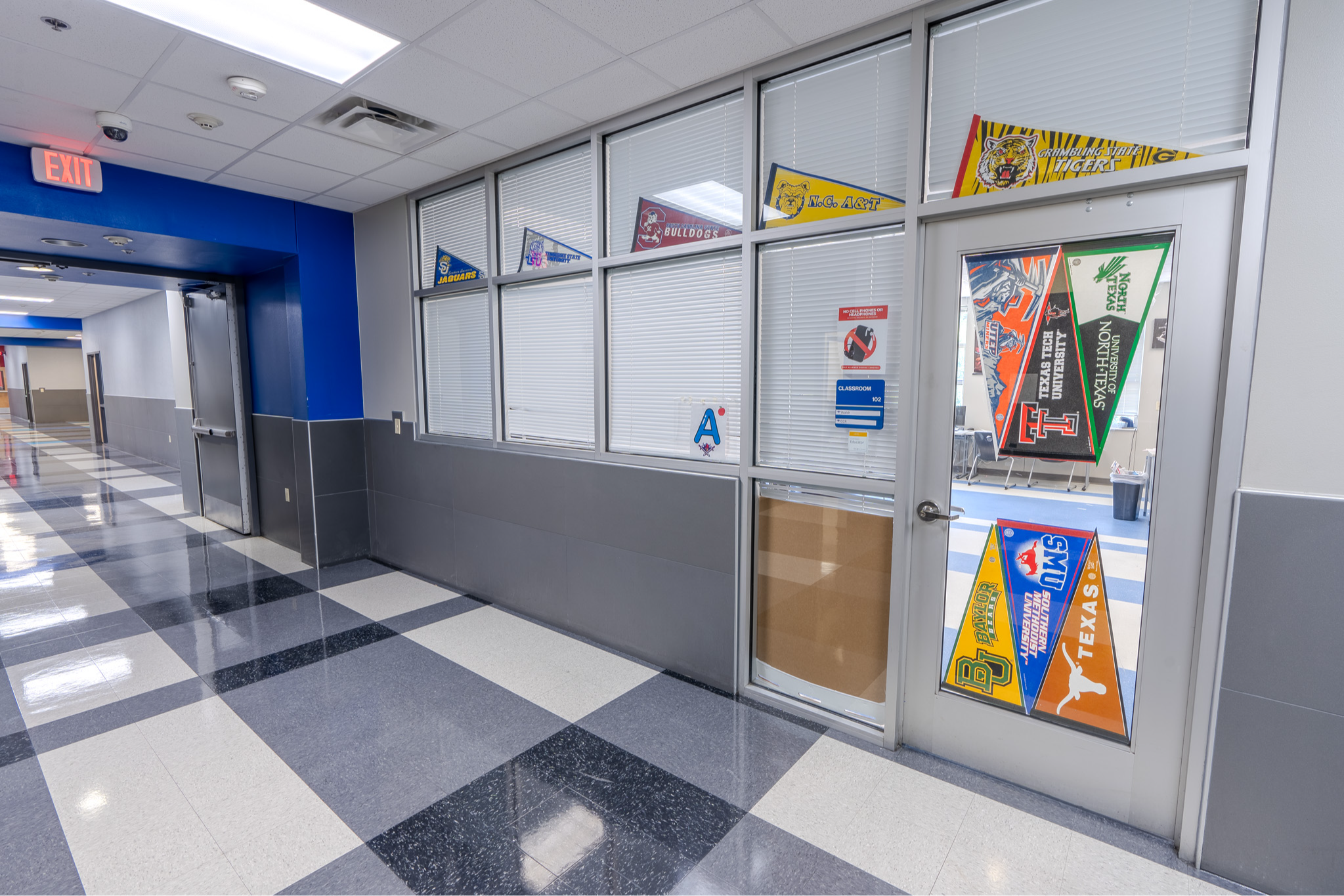 school hallway with college pennants hanging on the walls