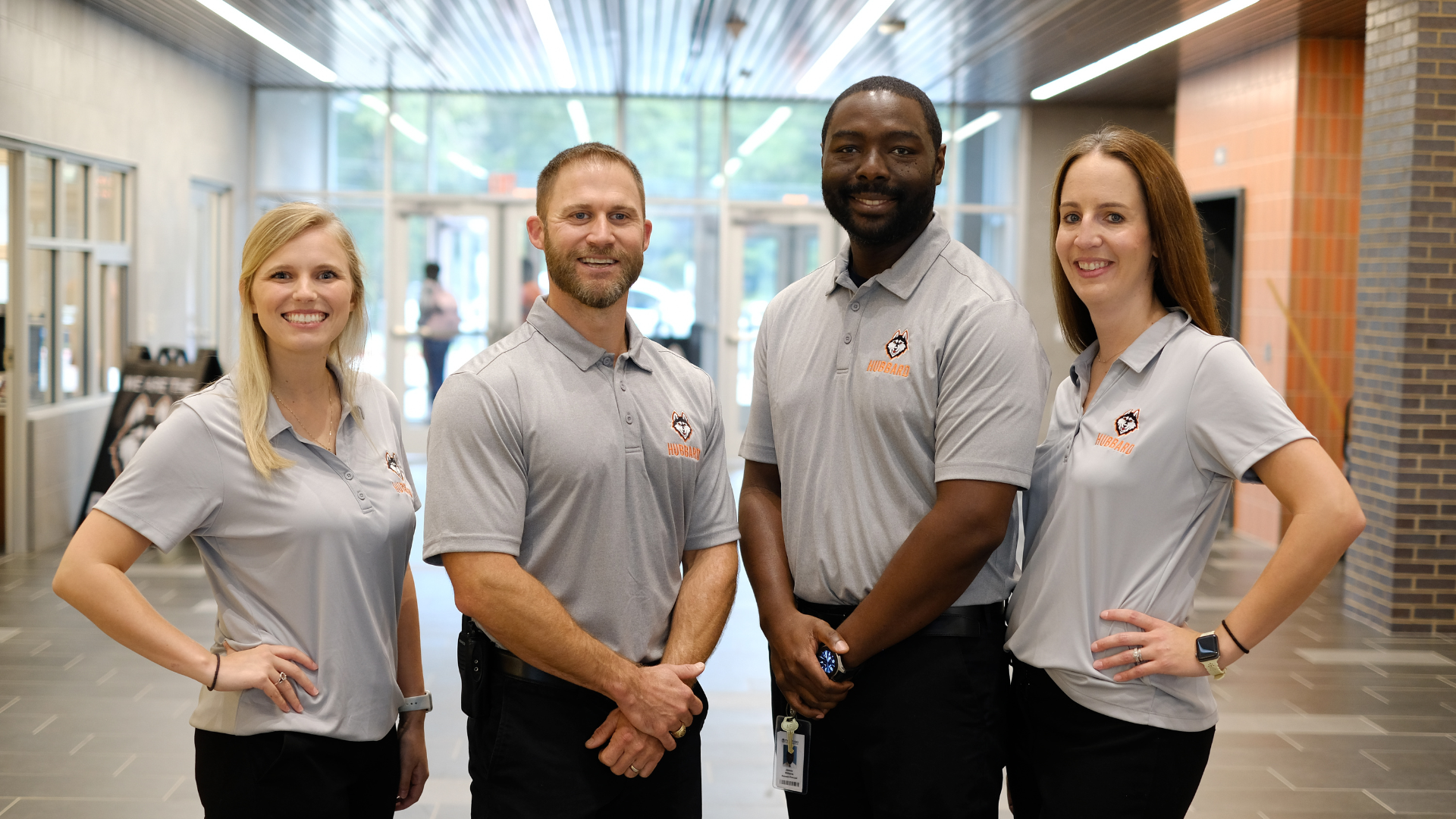 Campus administration staff standing in atrium