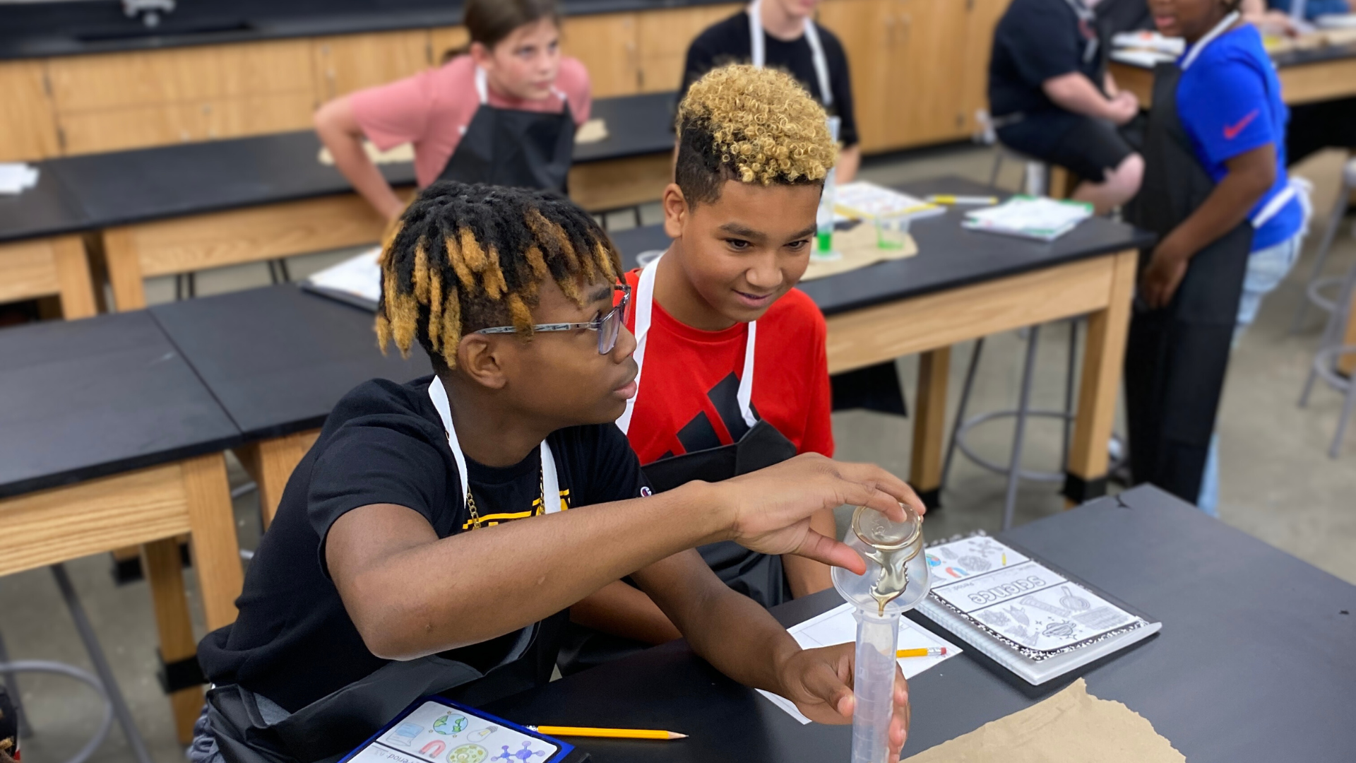 two students conducting a science experiment in a science lab