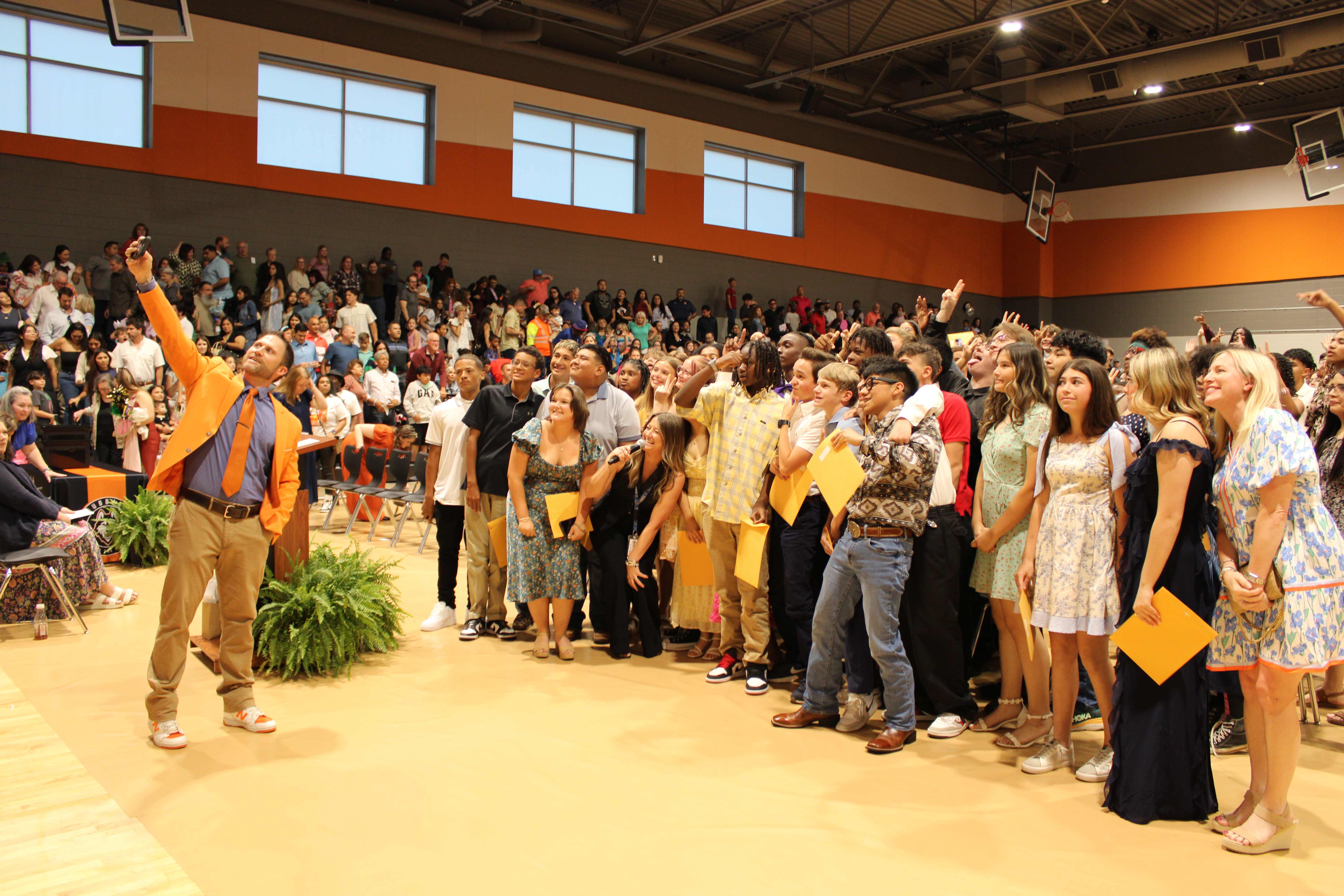 principal taking a selfie with a large group of students