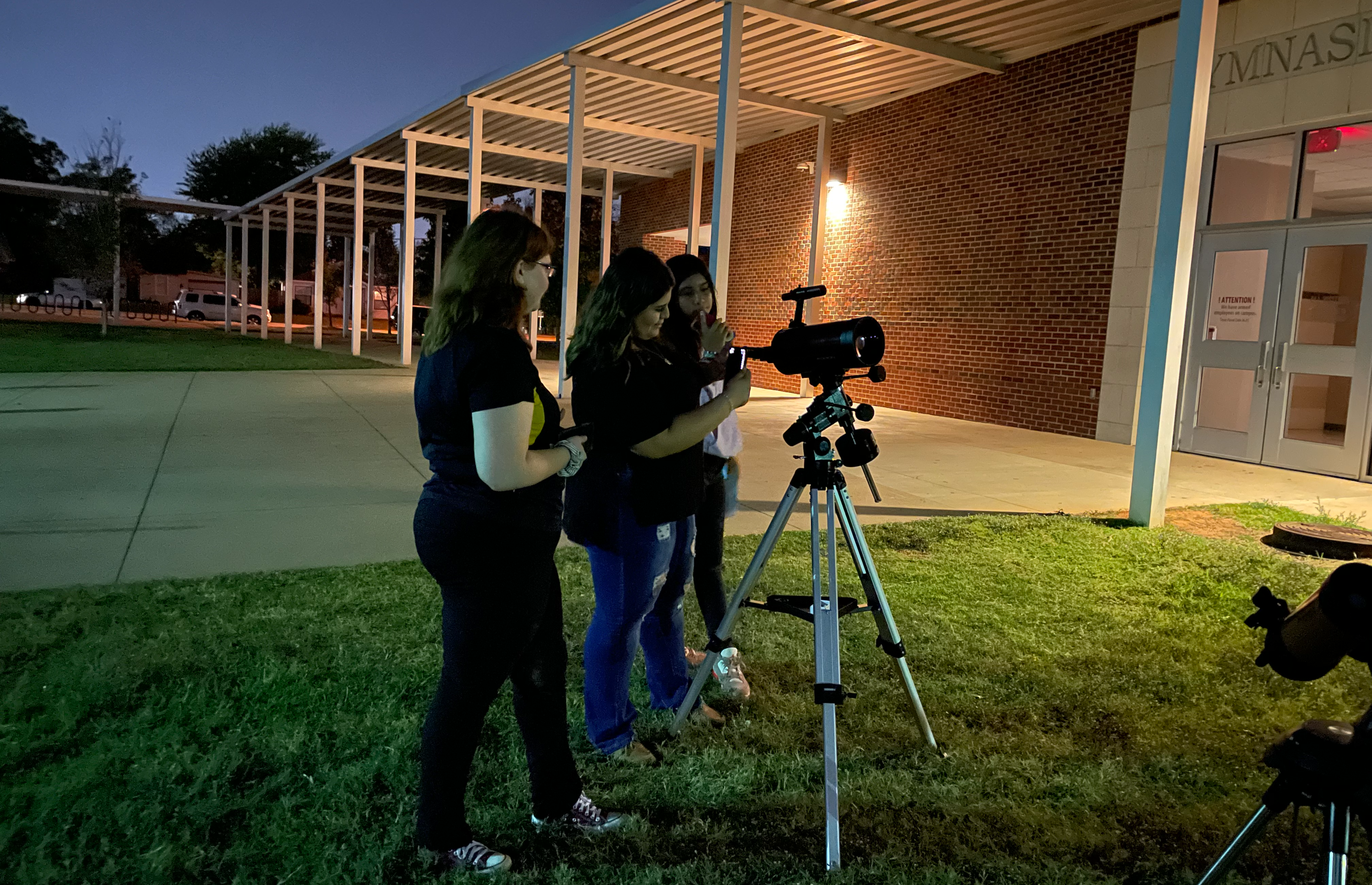 students working with telescope