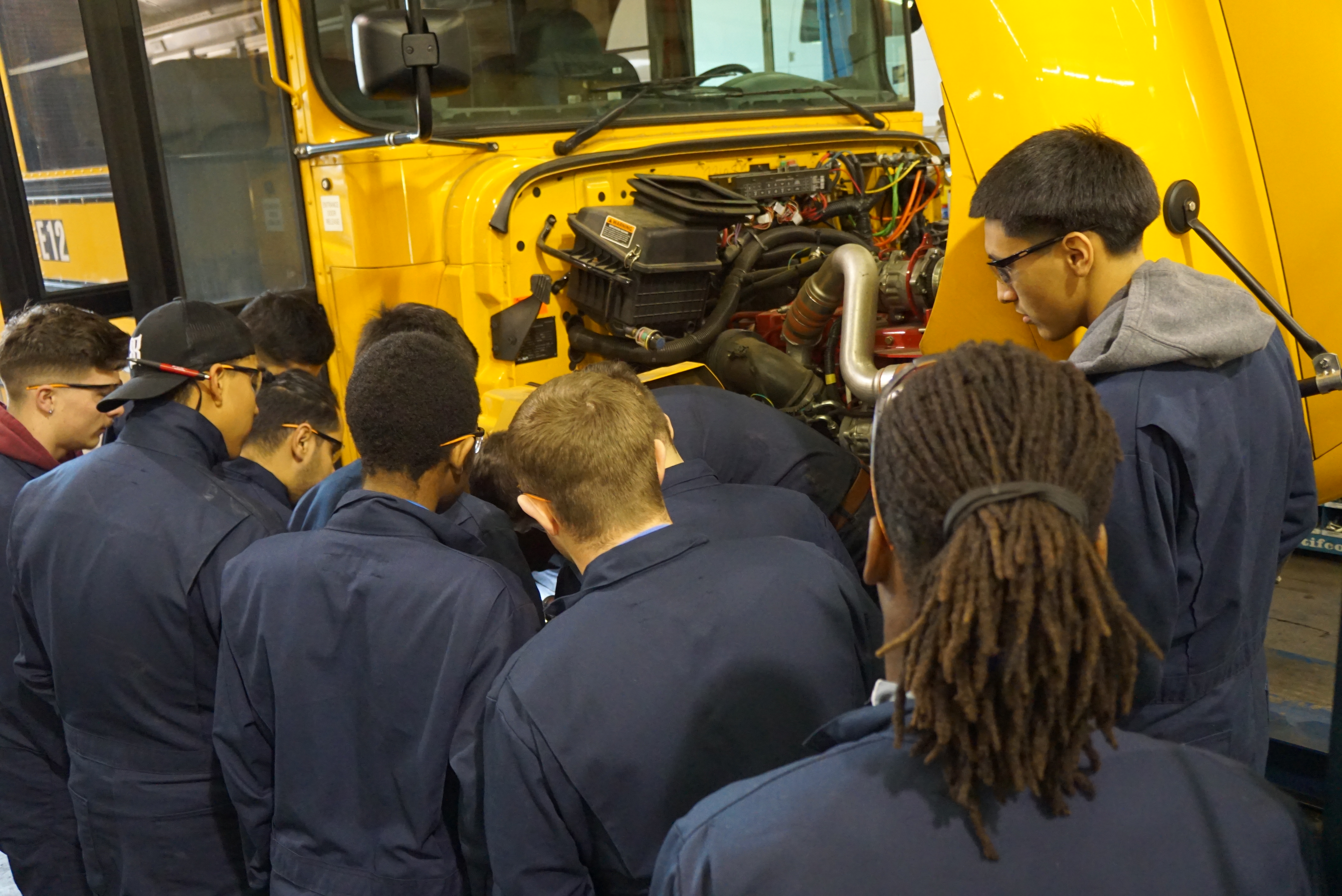 students learning about bus repair