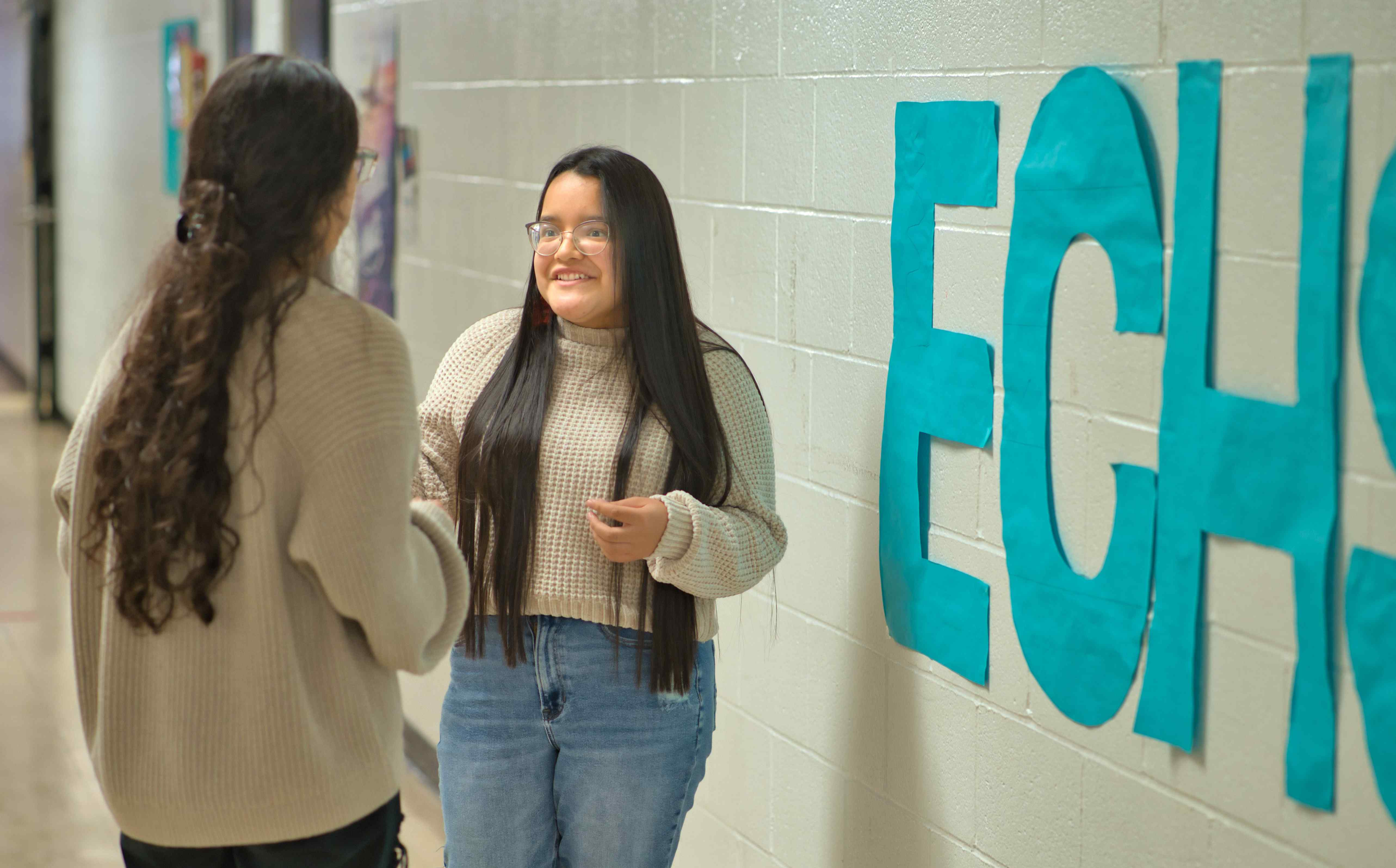 students speaking in hallway