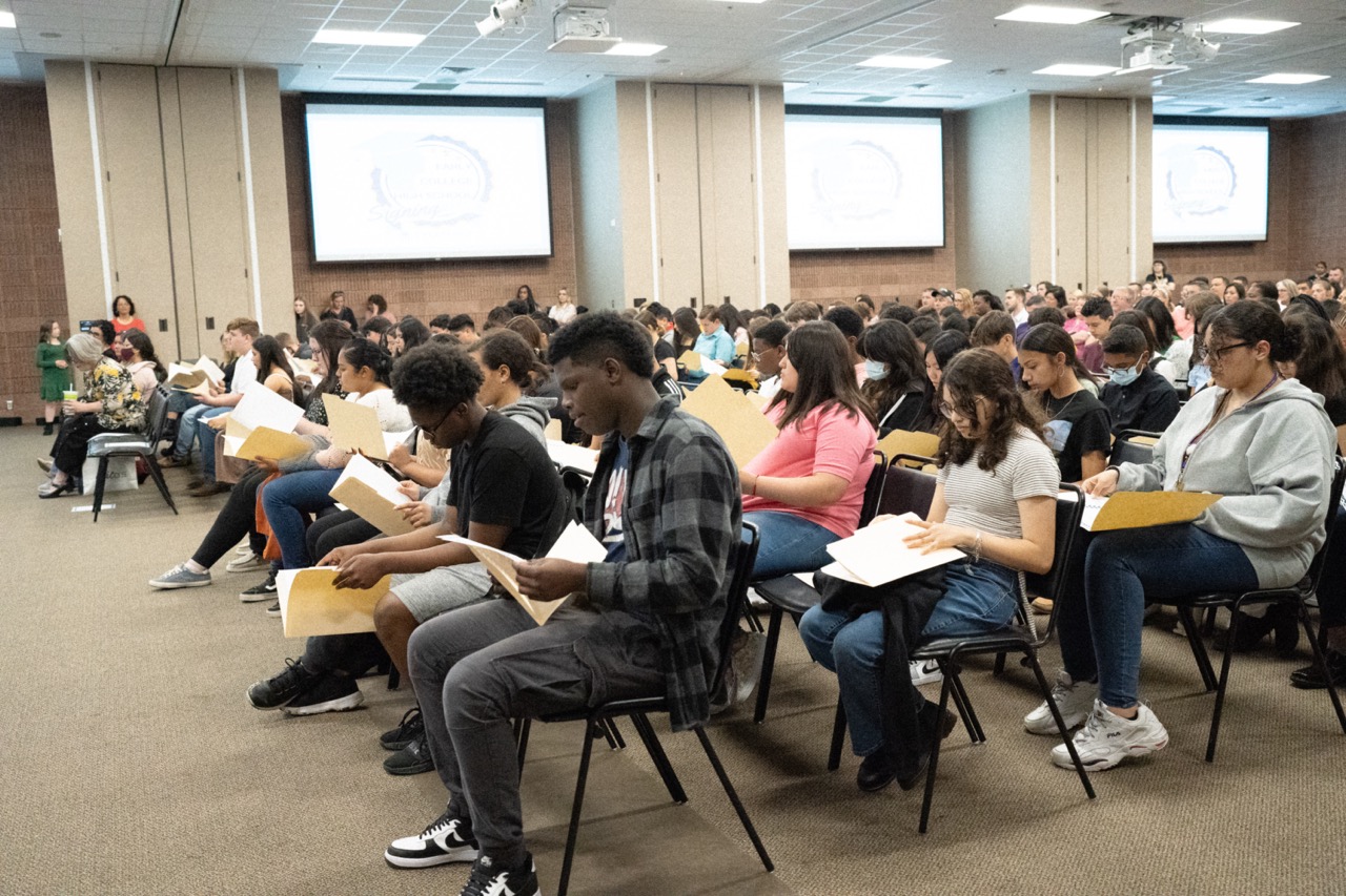 student at TJC signing