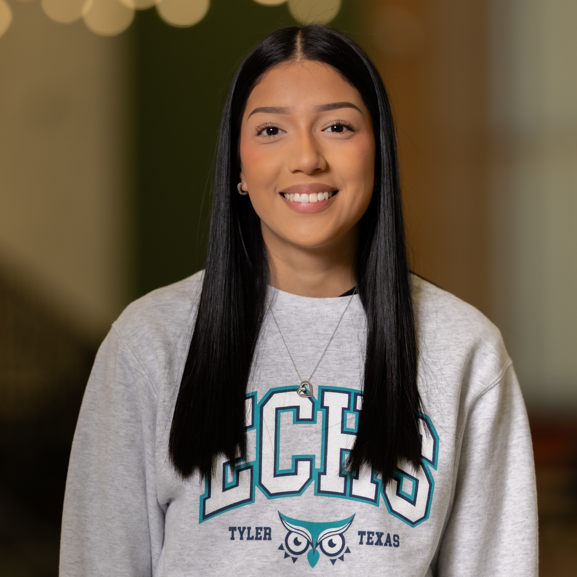 teen girl with long dark hair wearing an ECHS Tyler, Texas sweatshirt