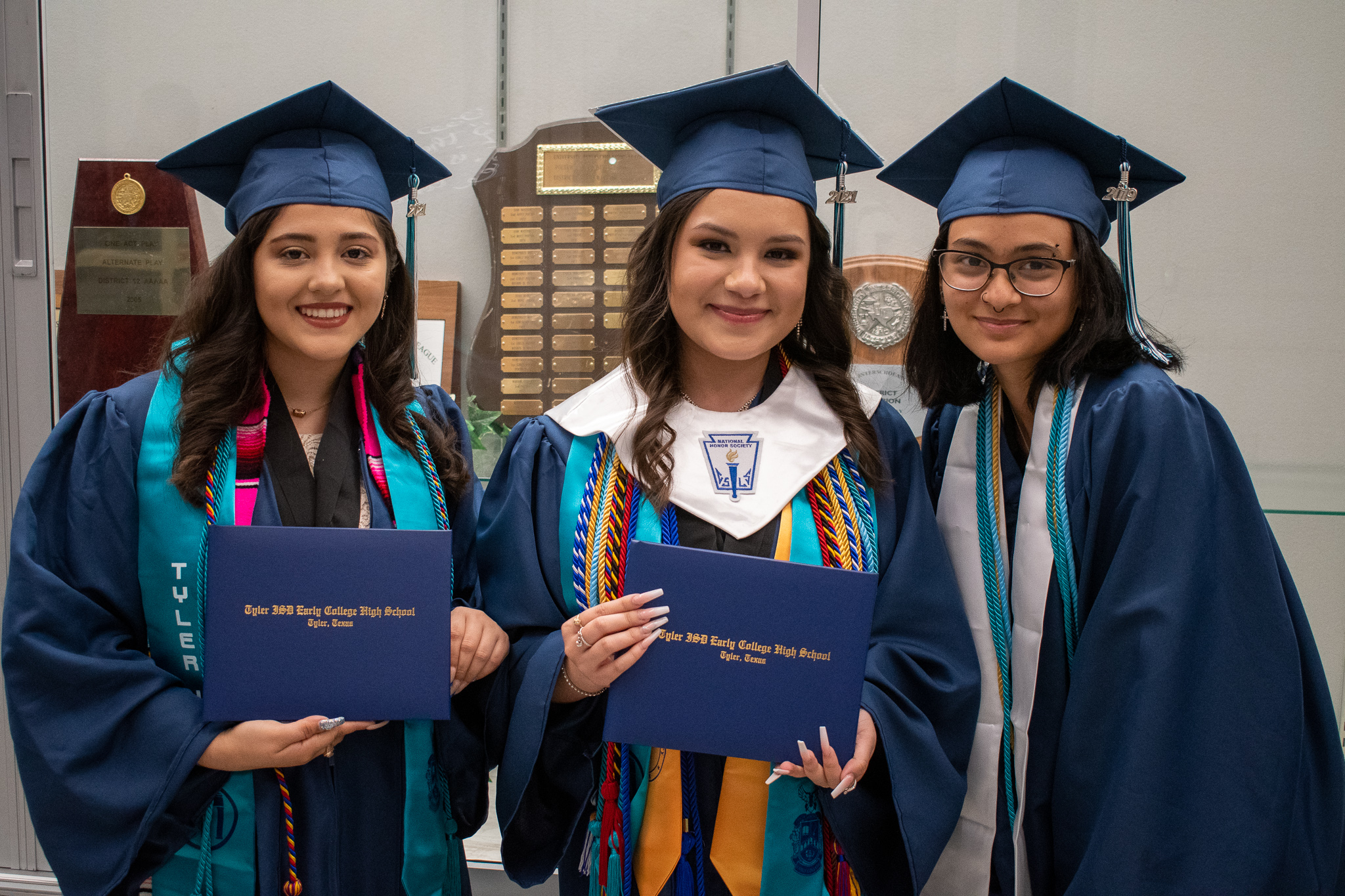 students posing at graduation