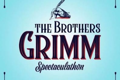 Blue background with decorative borders. Text reads "The Brothers Grimm Spectacleation" with a quill pen in a hand.