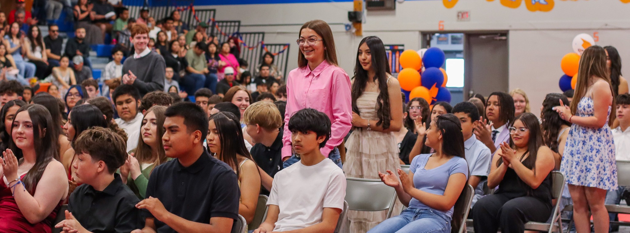 Students standing to be recognized at 8th Grade promotion ceremony