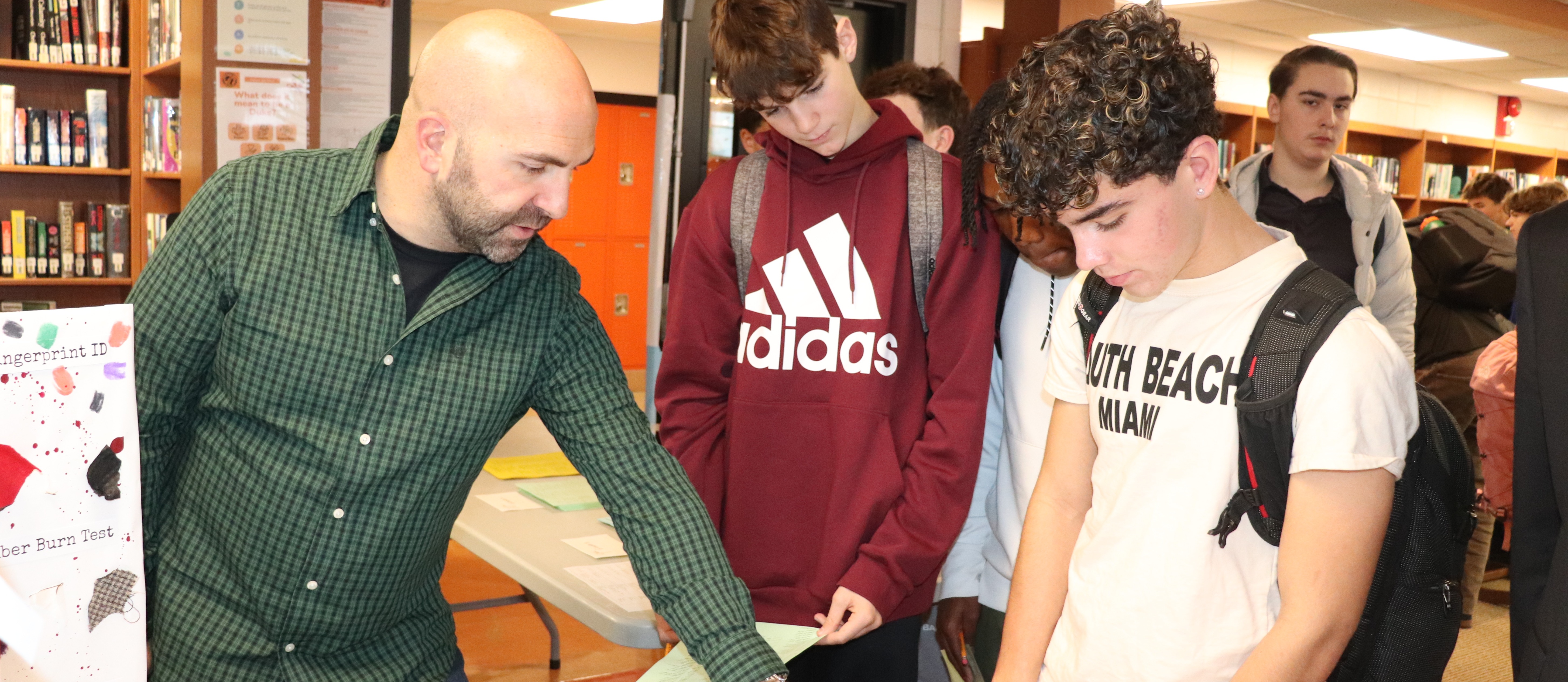 A teacher talking to two students