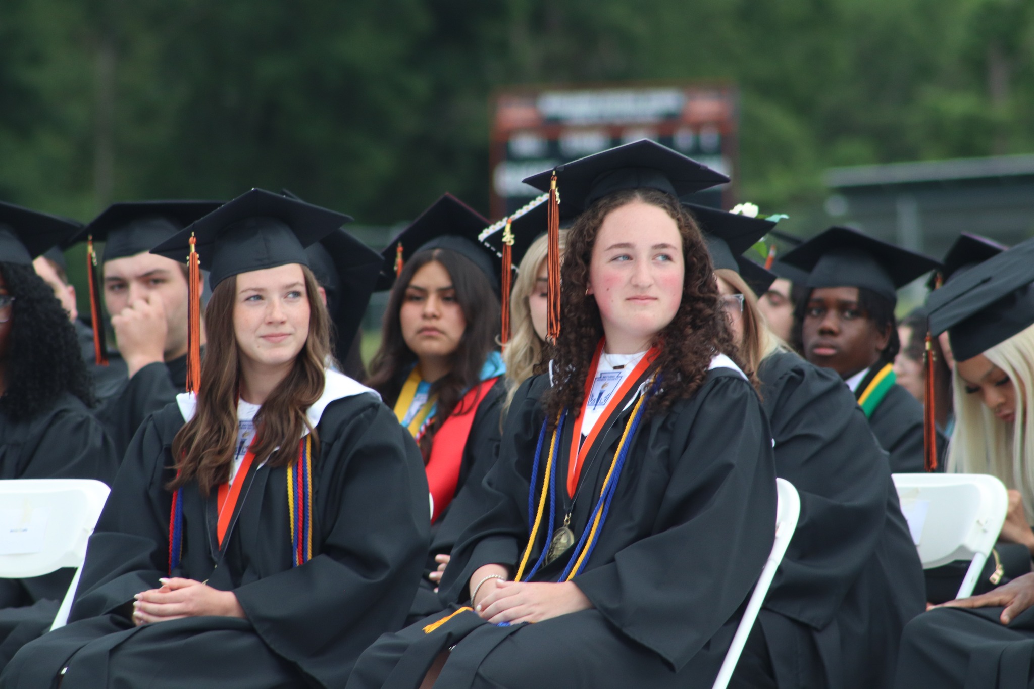 Graduates listen during commencement