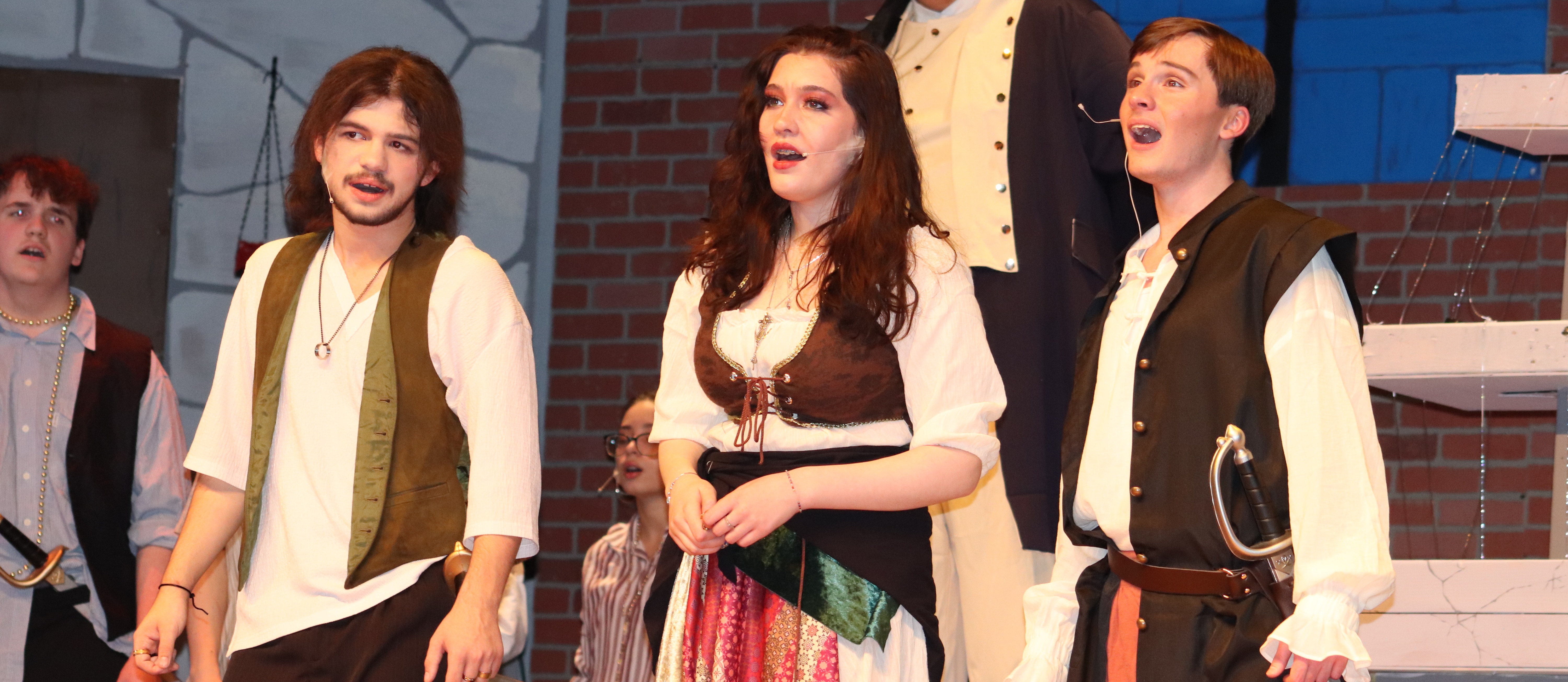 Cast members dresses as pirates on stage