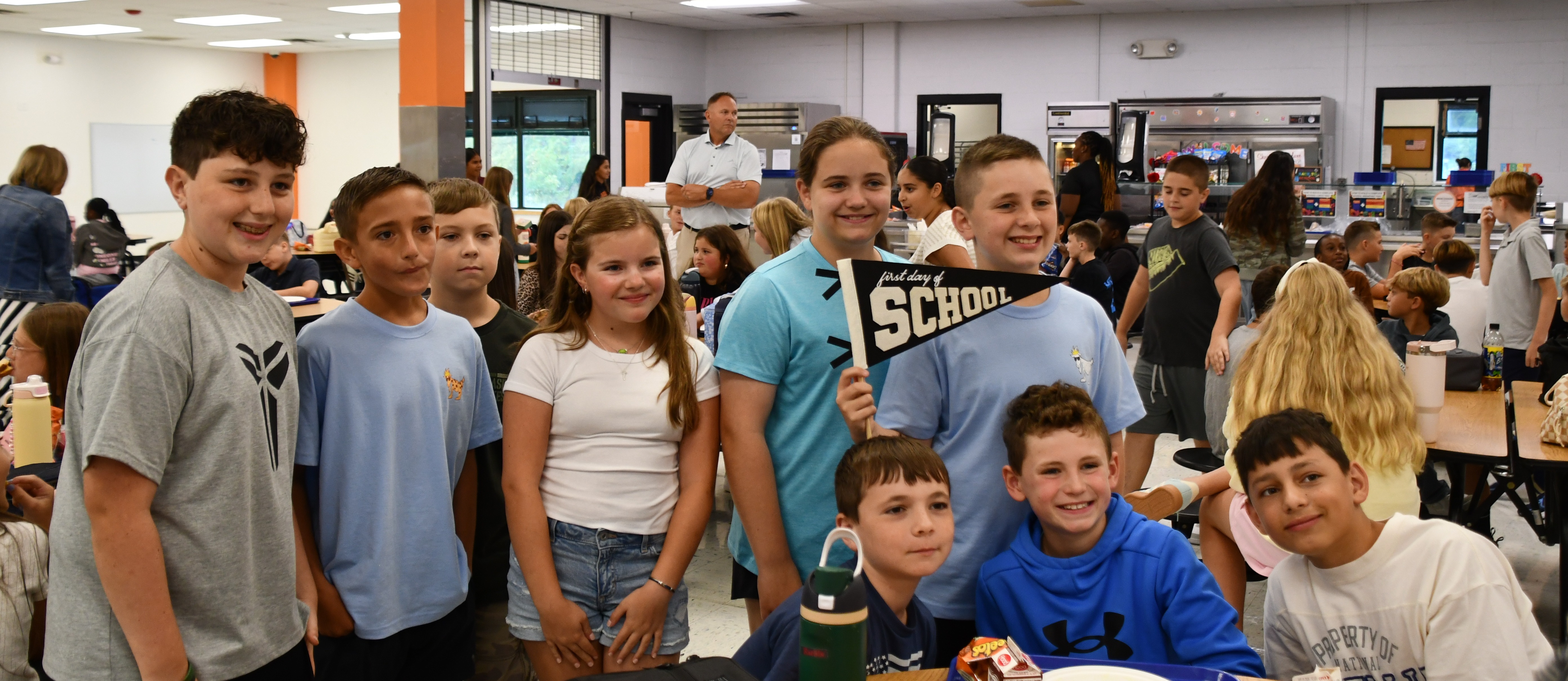 group of students standing by a lunch table