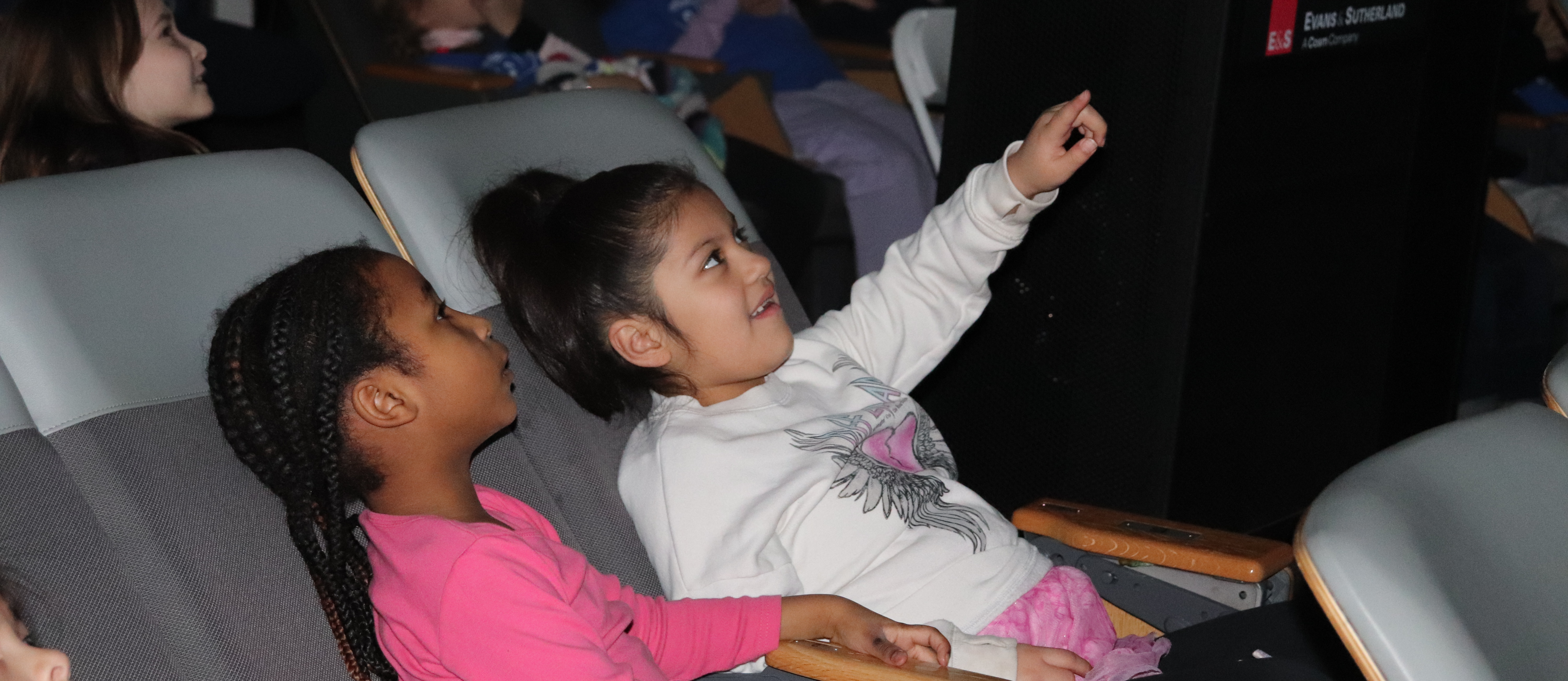 Two students sitting in a planetarium