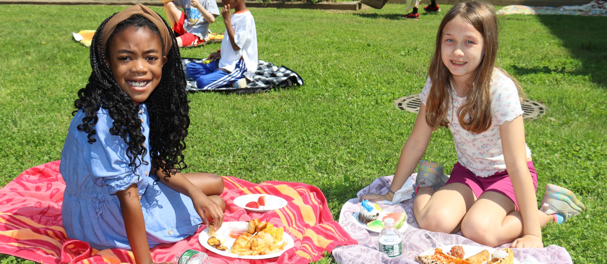 Two students enjoying an outdoor picnic