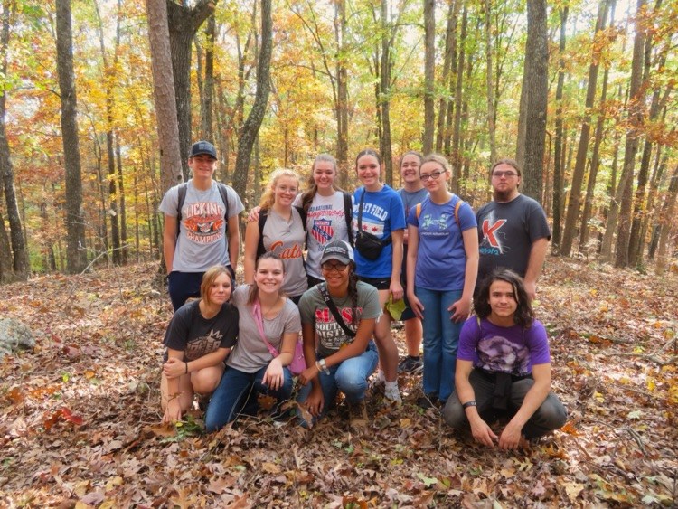 students hiking in the woods 