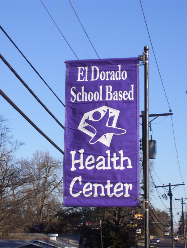A photo of a El Dorado School Based Health Center banner hanging on a street.