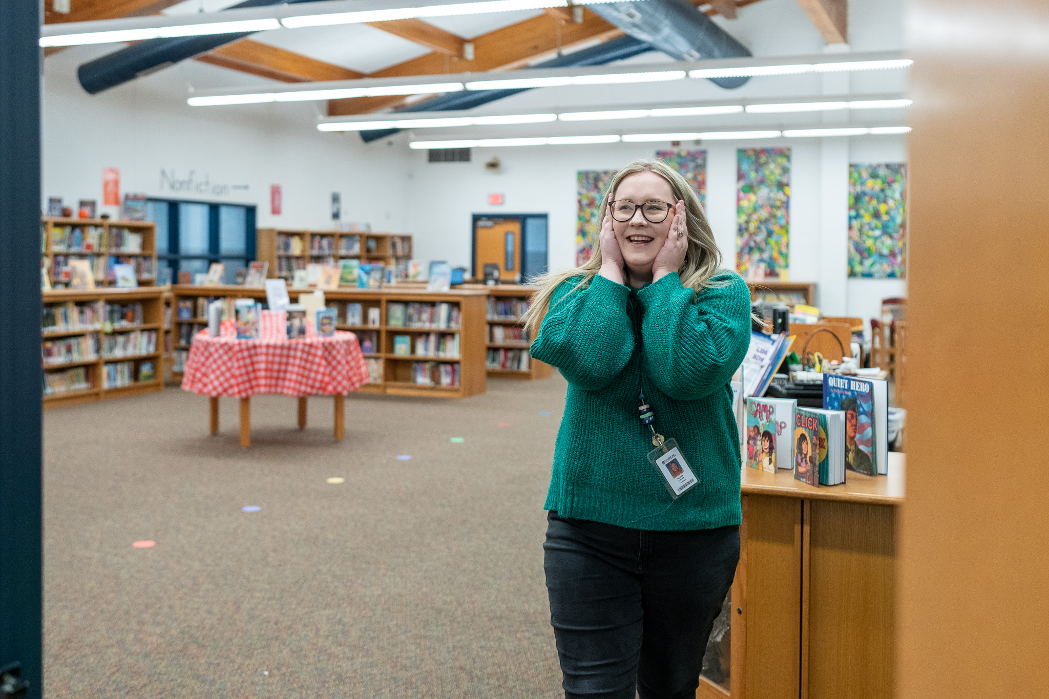 woman getting surprised with a giant check for a grant