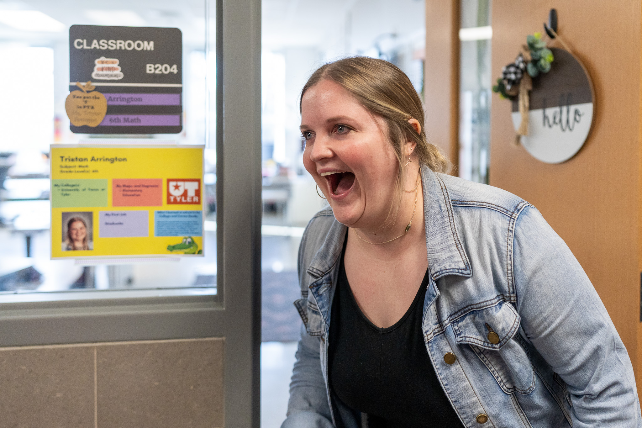 woman getting surprised with a giant check for a grant