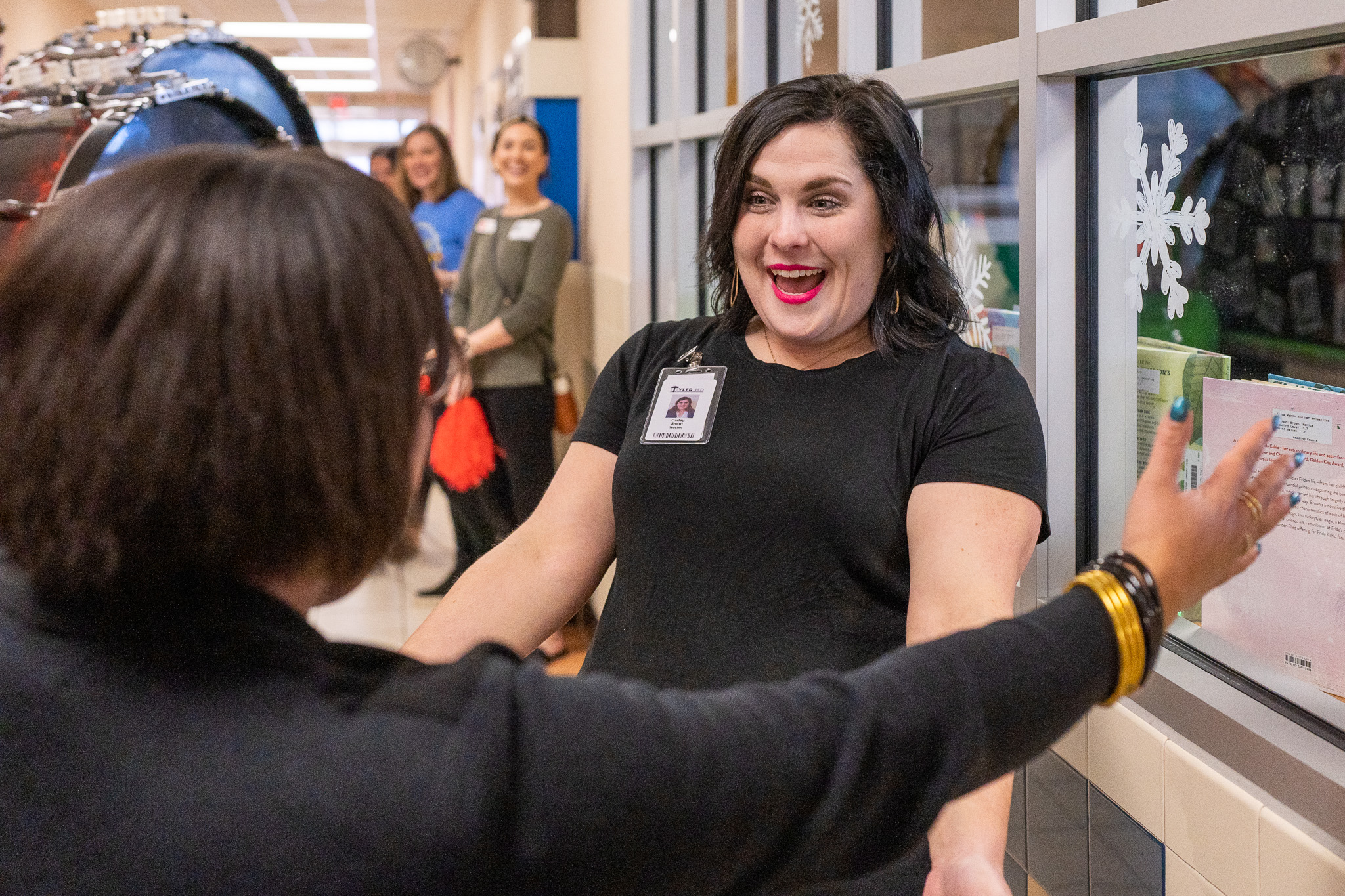 woman getting surprised with a giant check for a grant