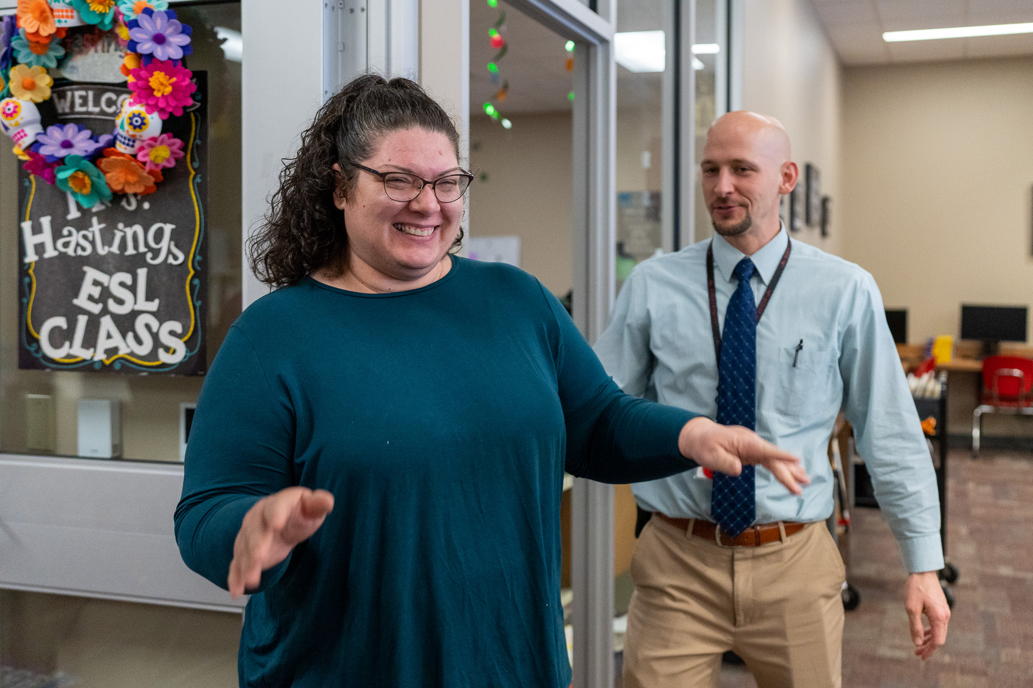 woman getting surprised with a giant check for a grant