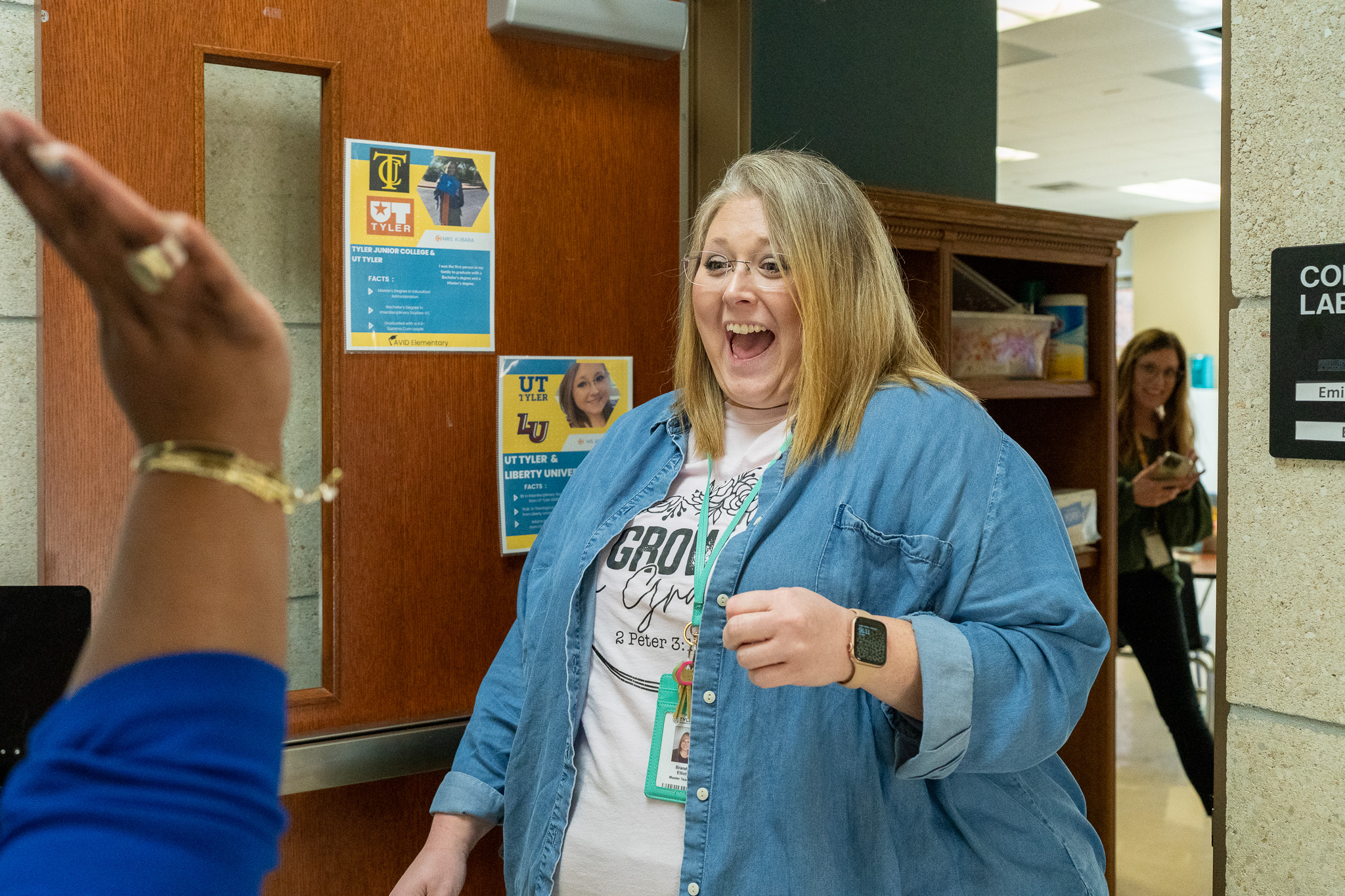 woman getting surprised with a giant check for a grant