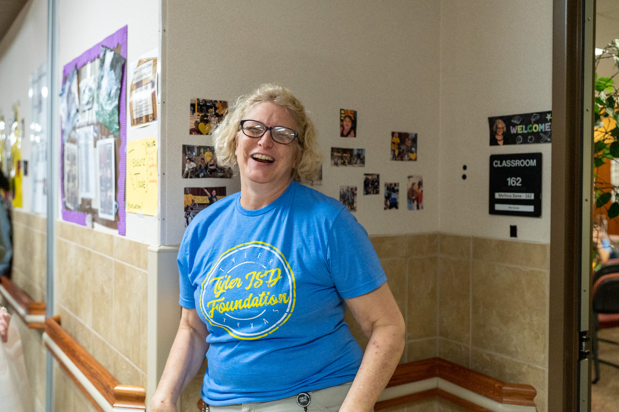 woman getting surprised with a giant check for a grant