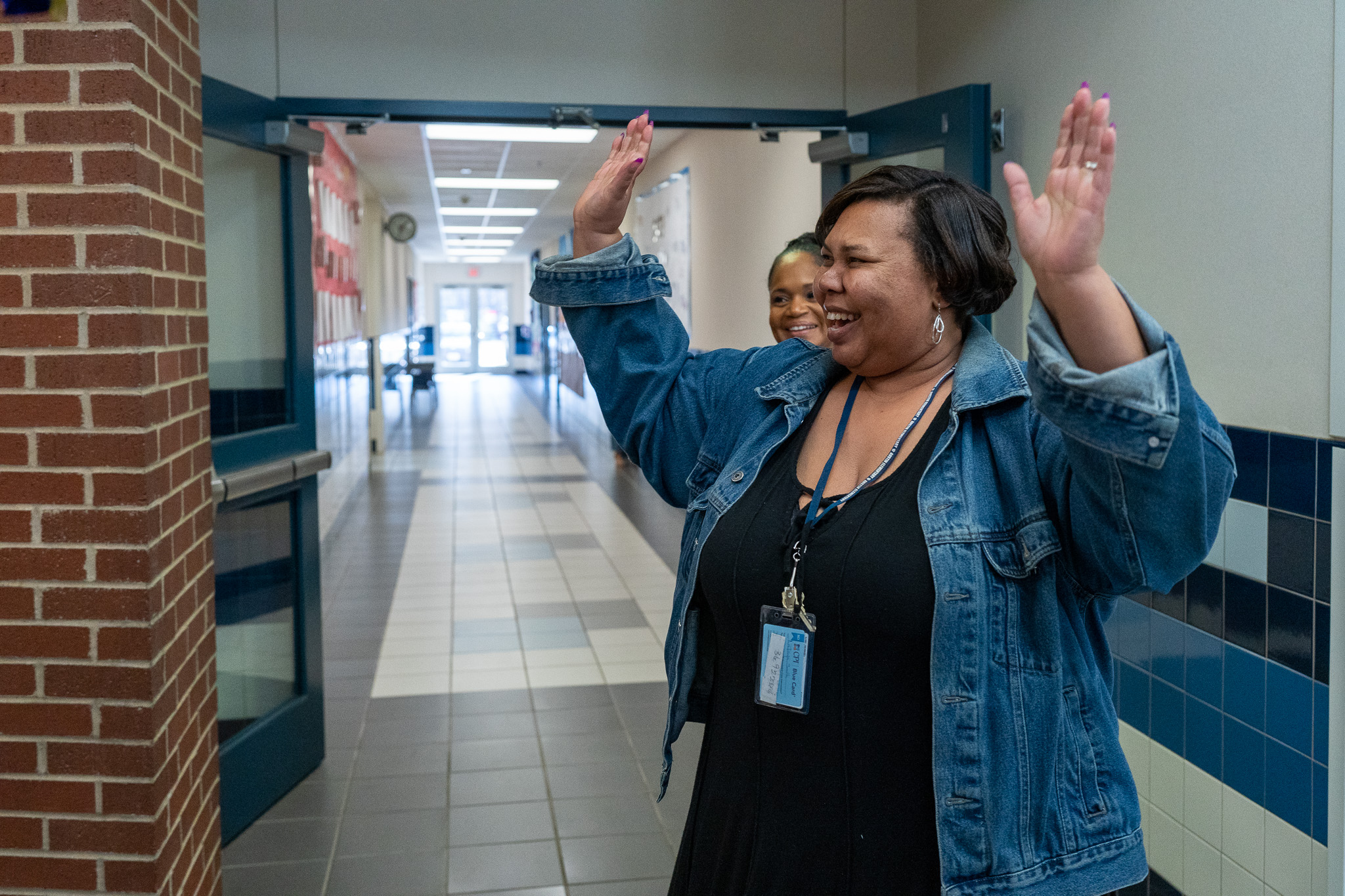 woman getting surprised with a giant check for a grant