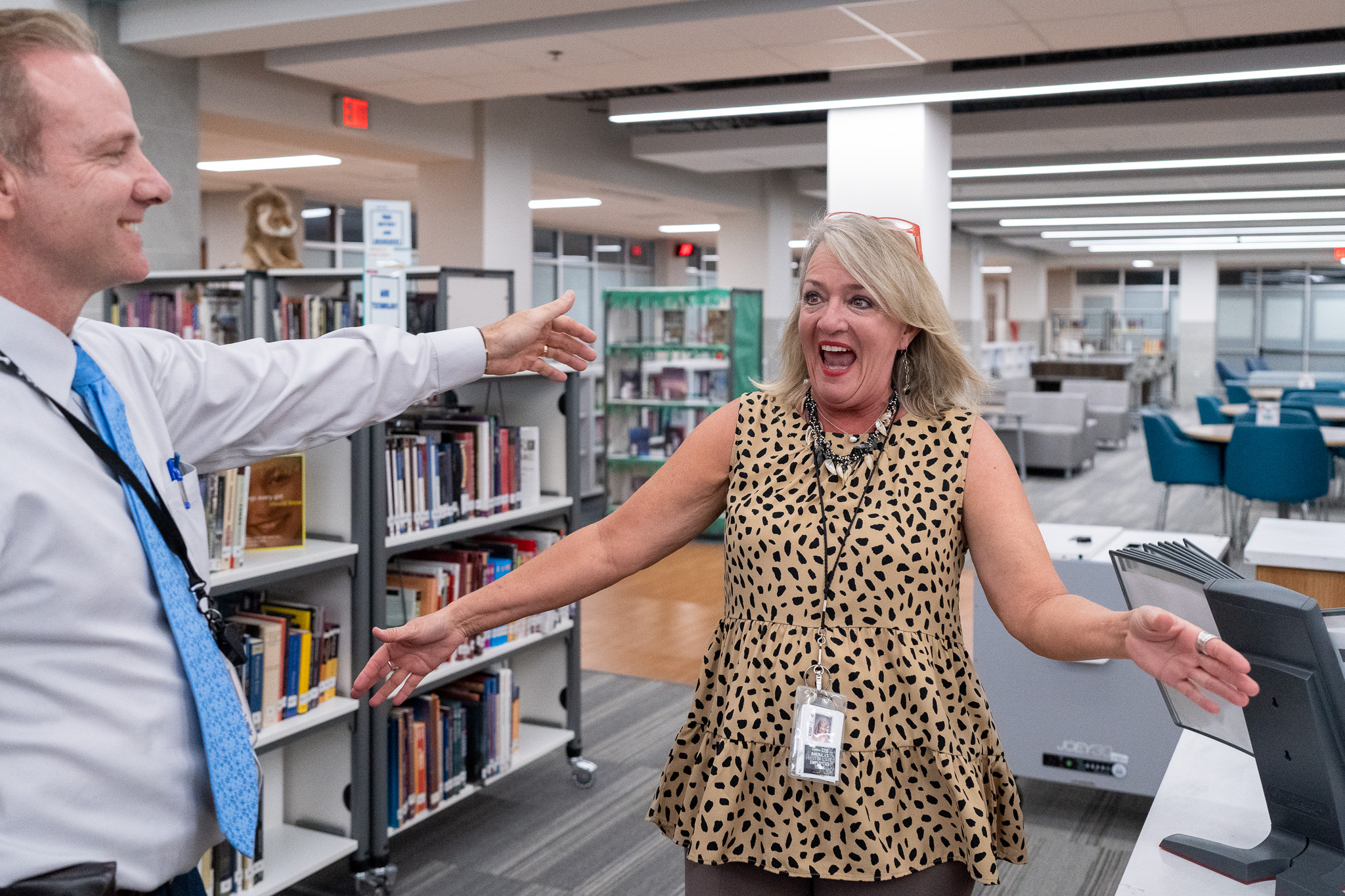 woman getting surprised with a giant check for a grant