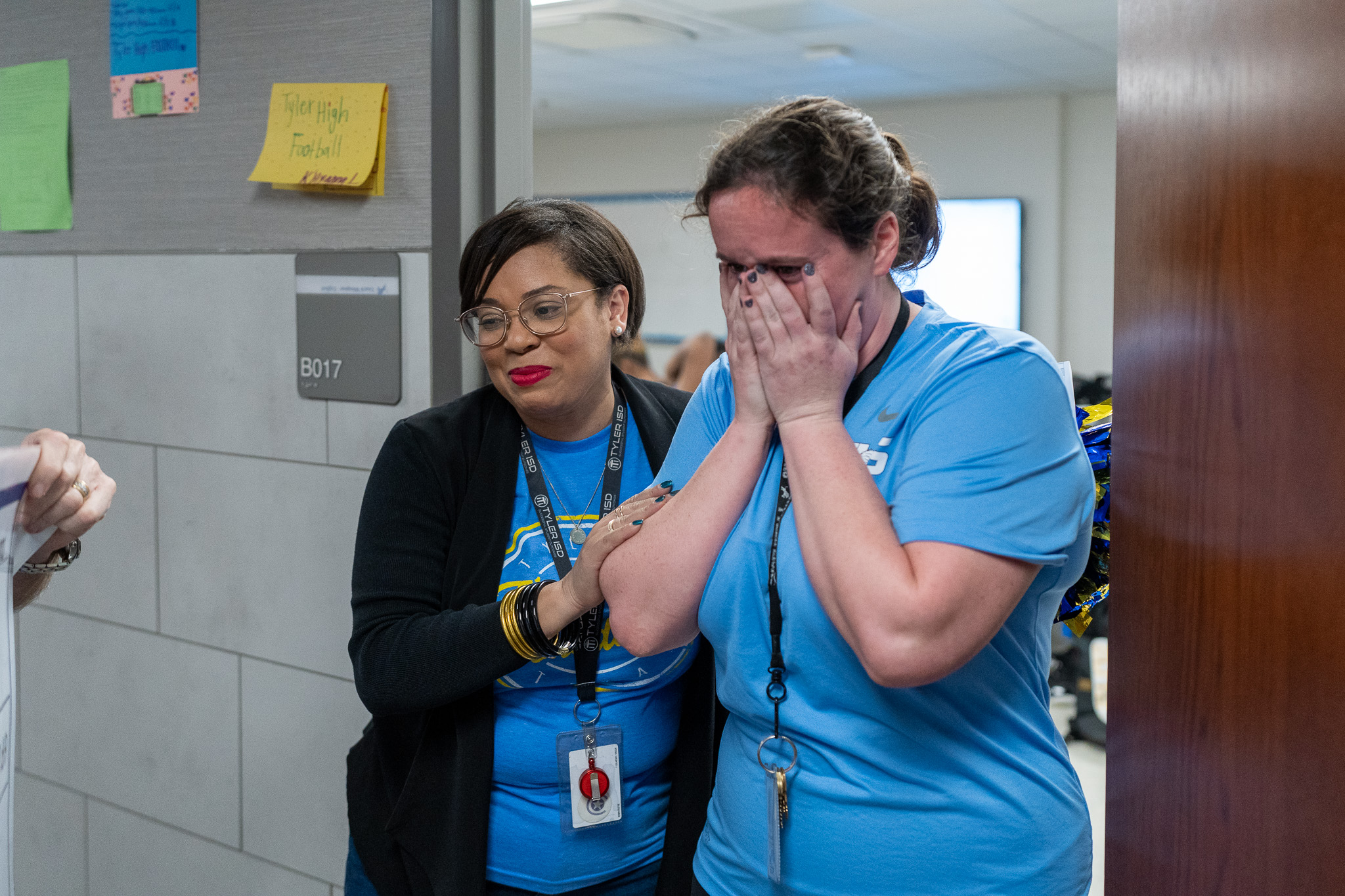 woman getting surprised with a giant check for a grant