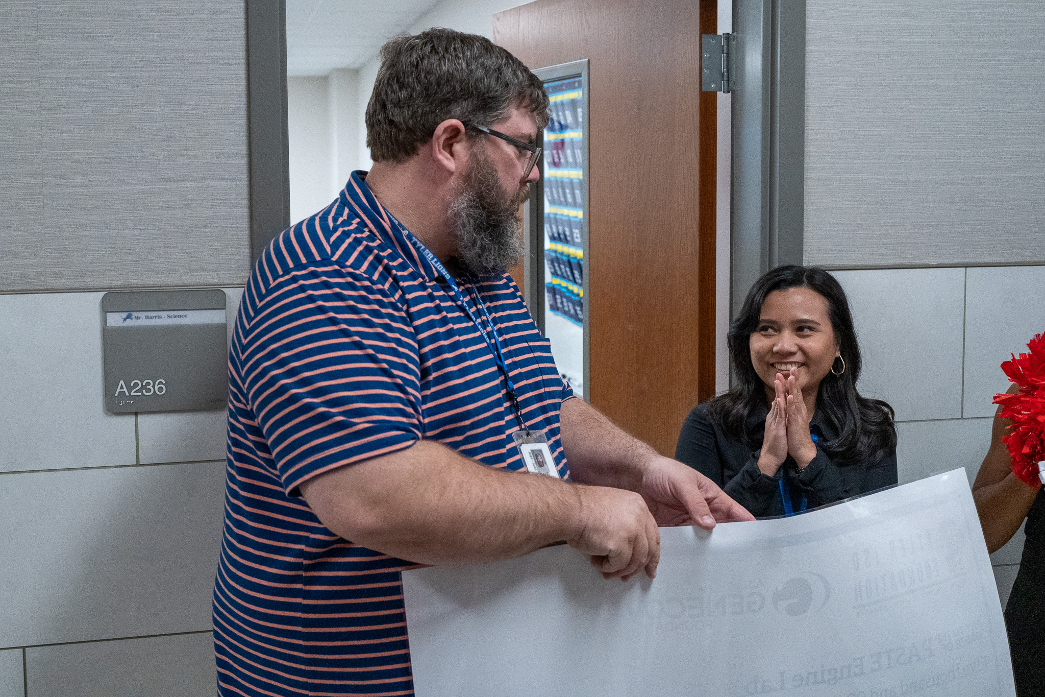 man getting surprised with a giant check for a grant