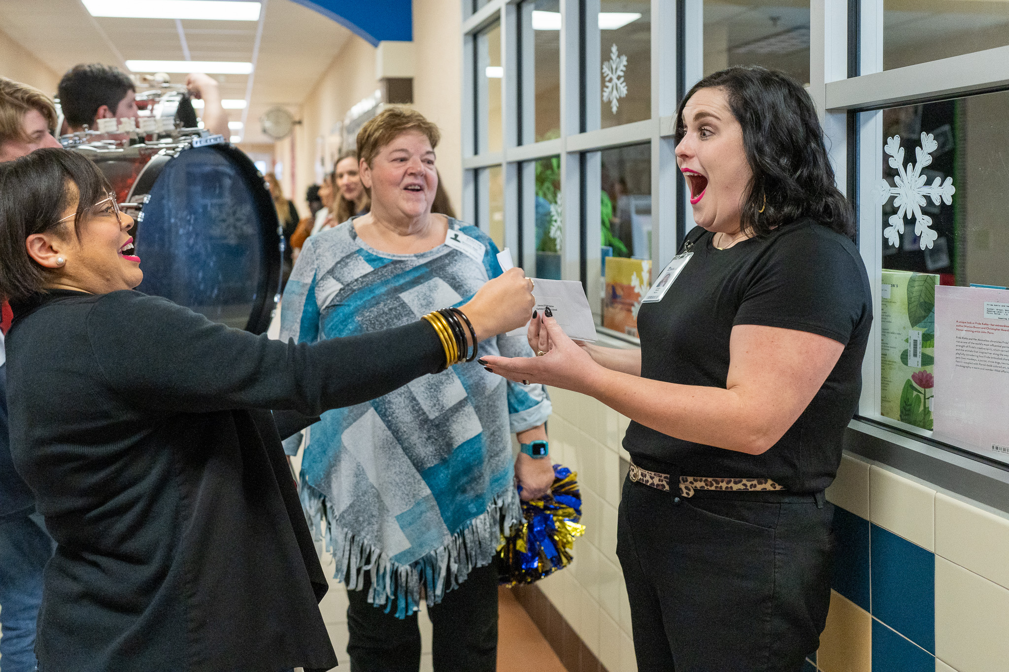 woman getting surprised with a giant check for a grant