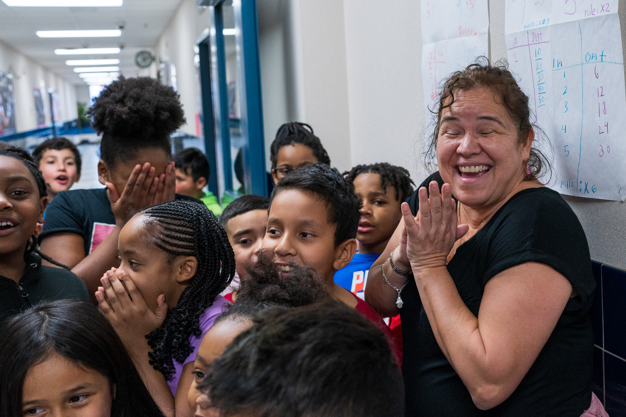 woman with excited expression on face with students around her