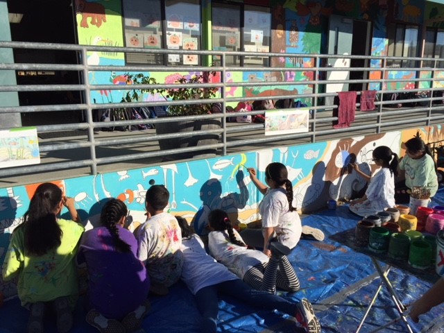 Students painting murals at PES