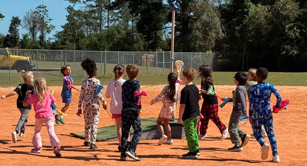 Students get closer to the goal while playing stickball.