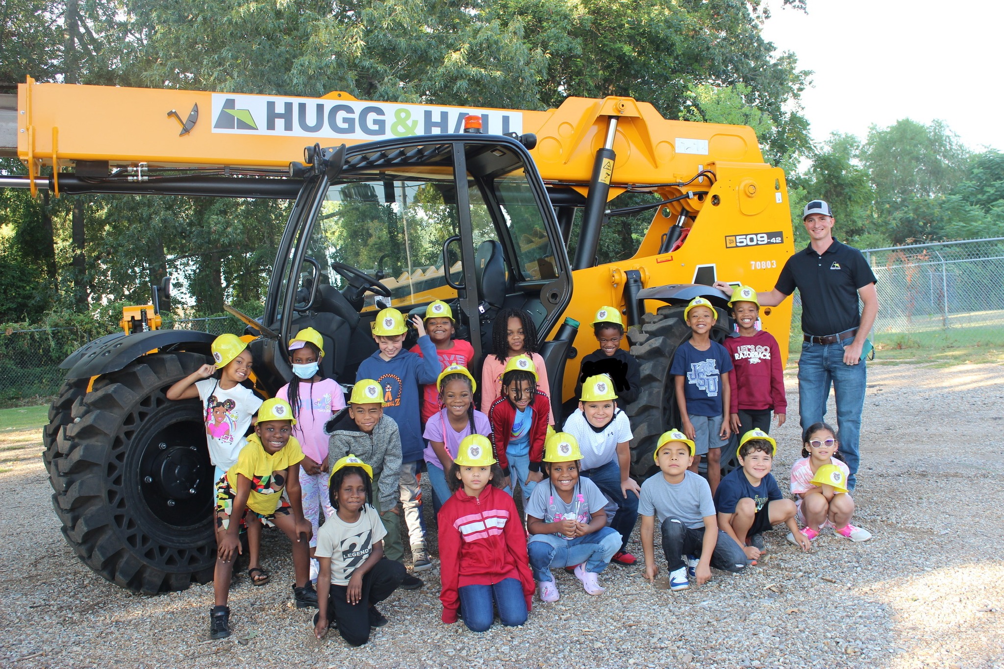 students standing in front of construction equipment