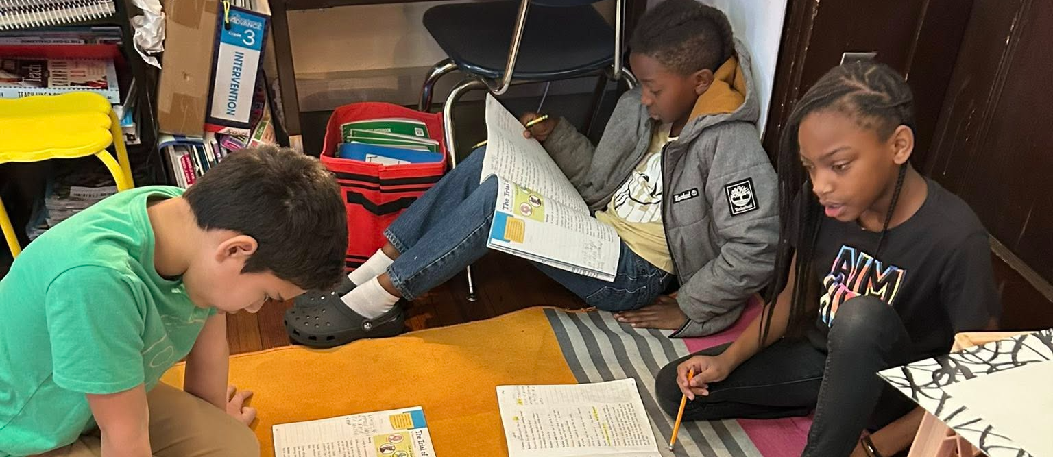 students reading together on the floor