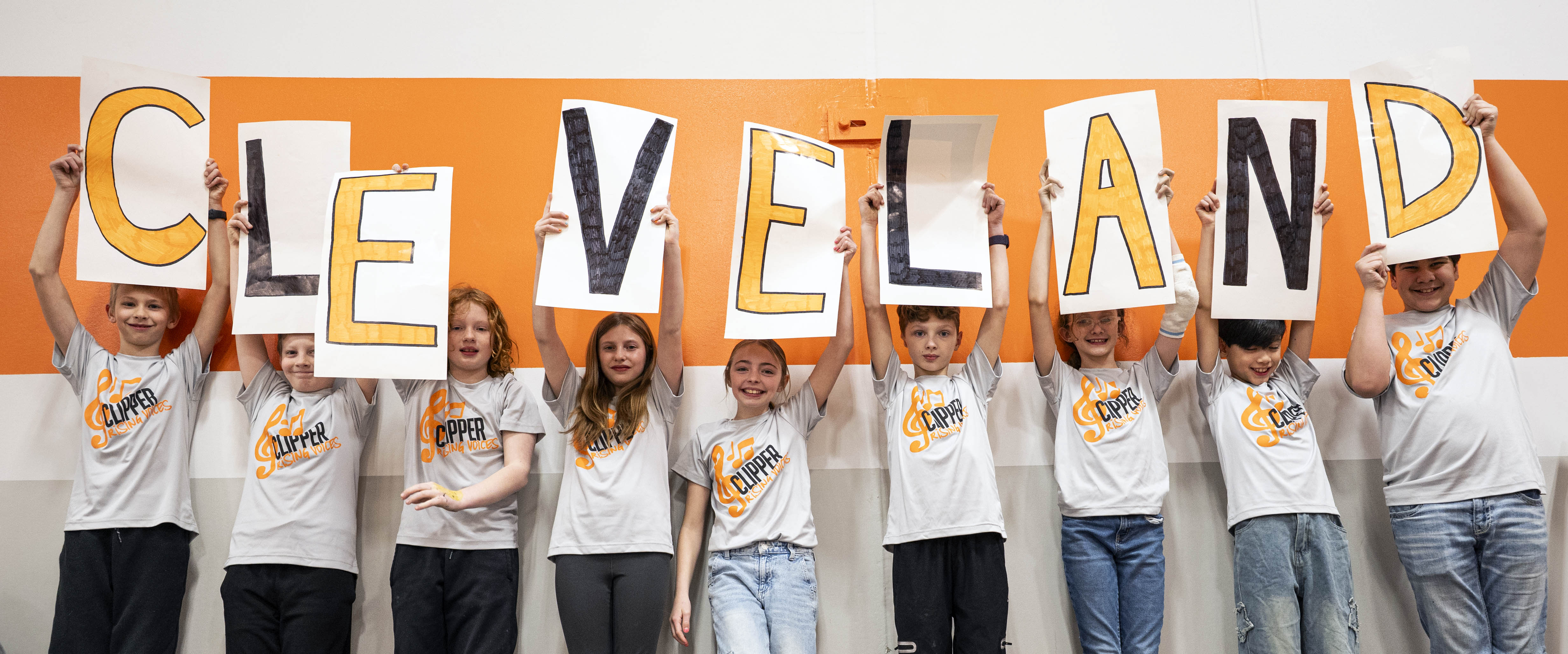 kids holding up letters