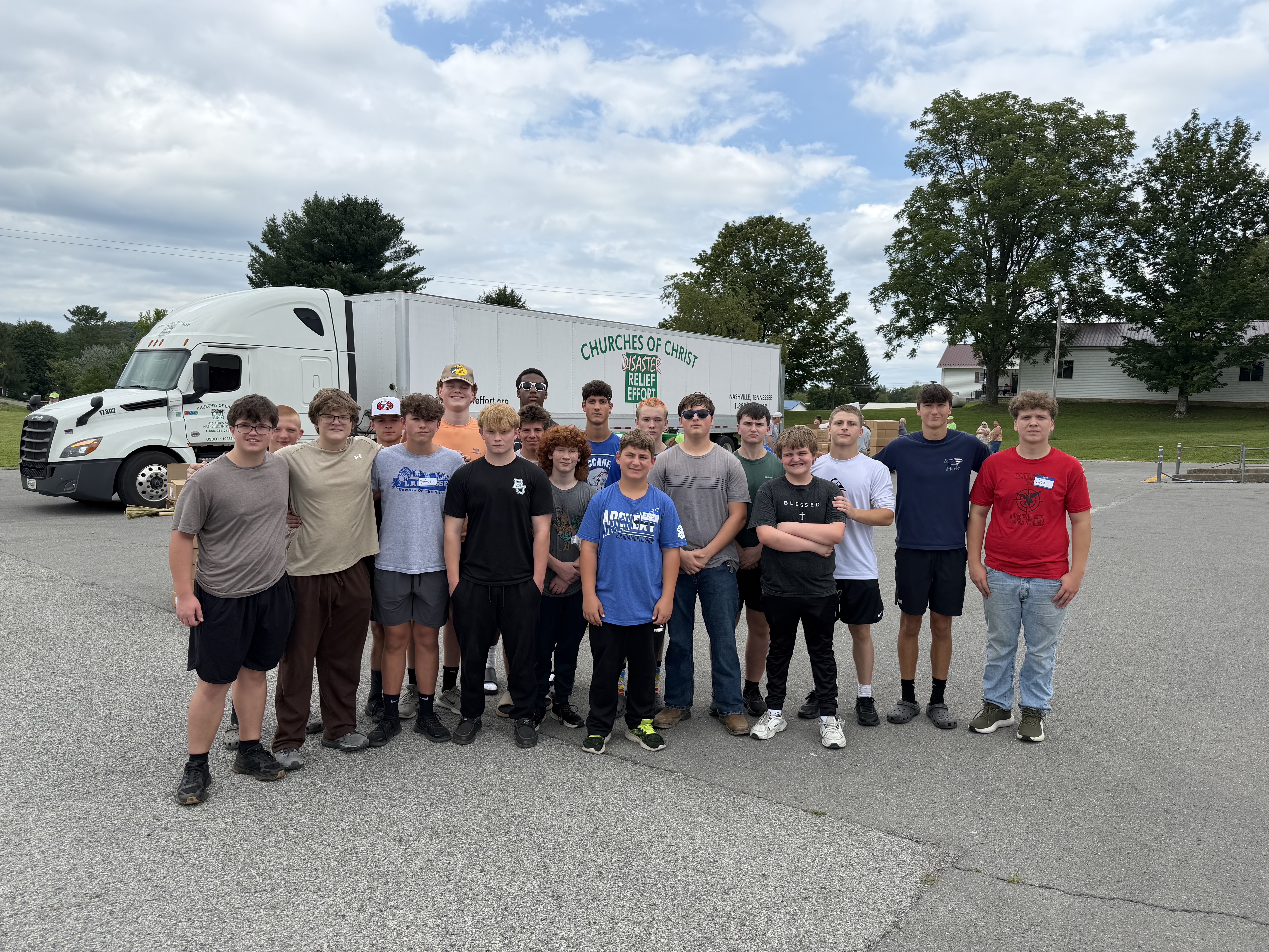 members of the football team following service following flood relief