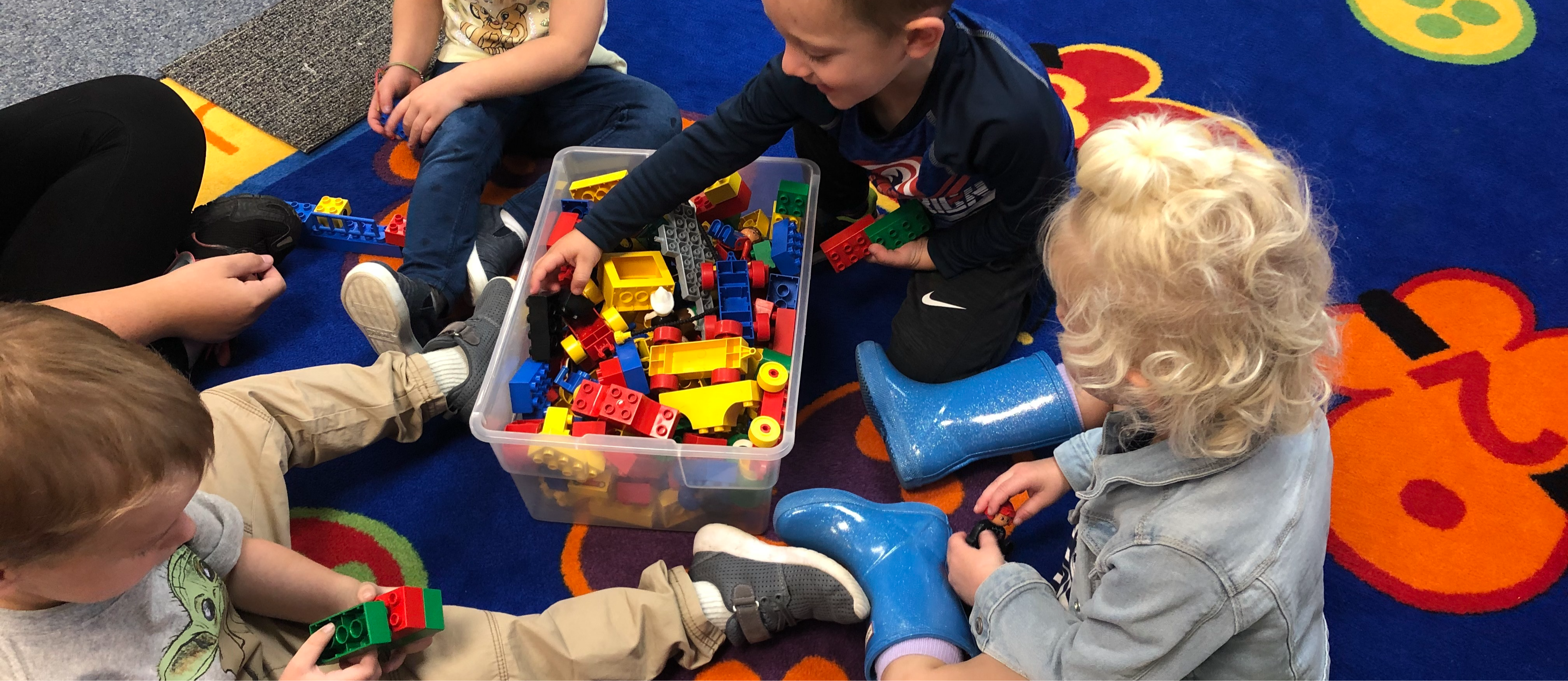 Young children playing with brightly colored blocks