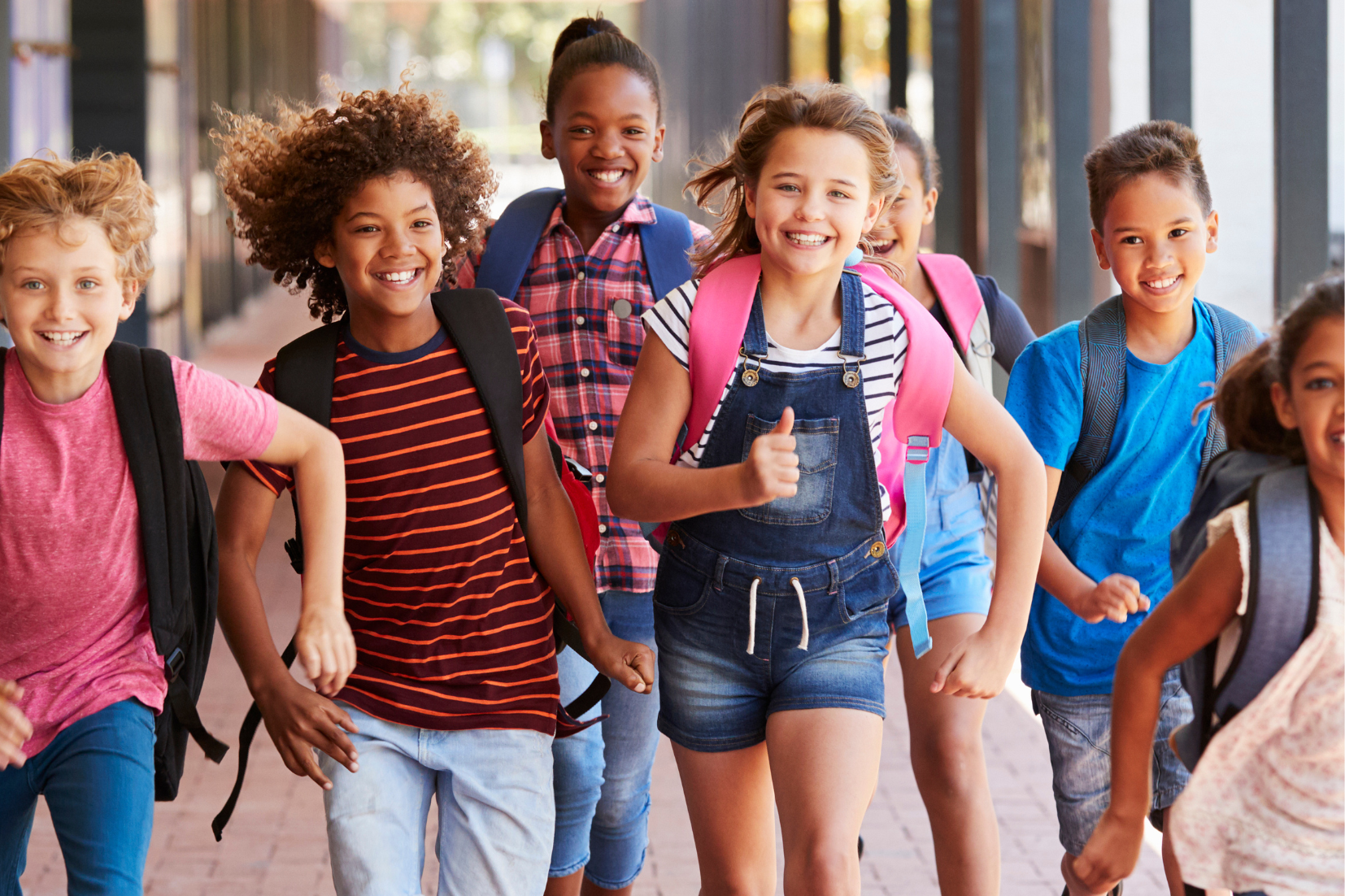 elementary school students run outside