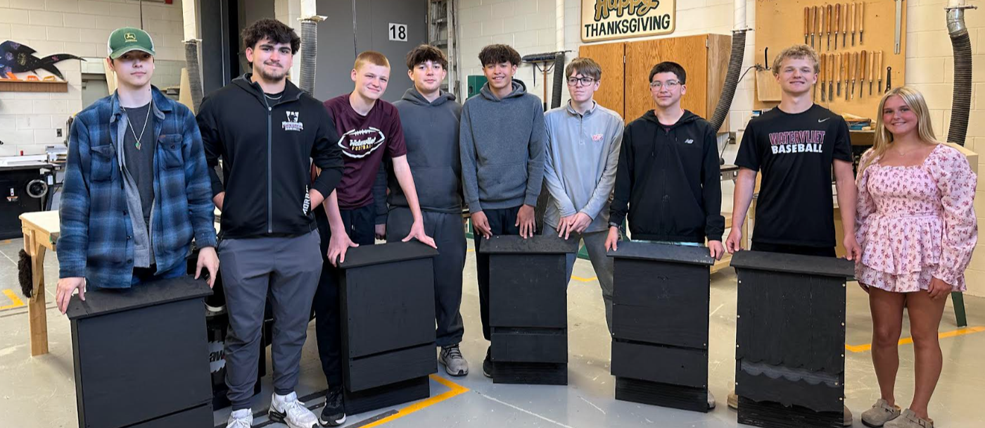 Woodshop students displaying Bat Houses that they made