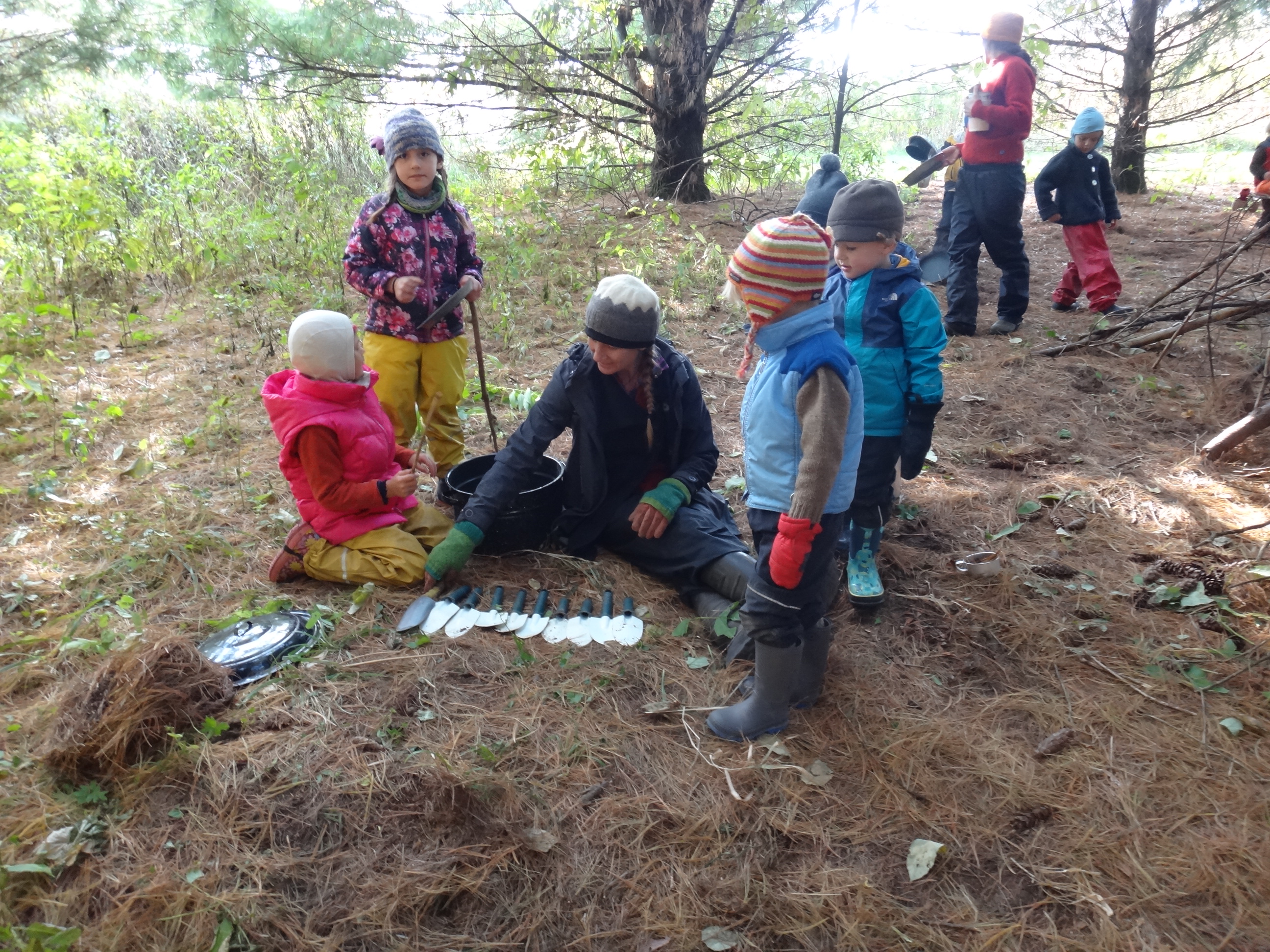 children looking at hand spades
