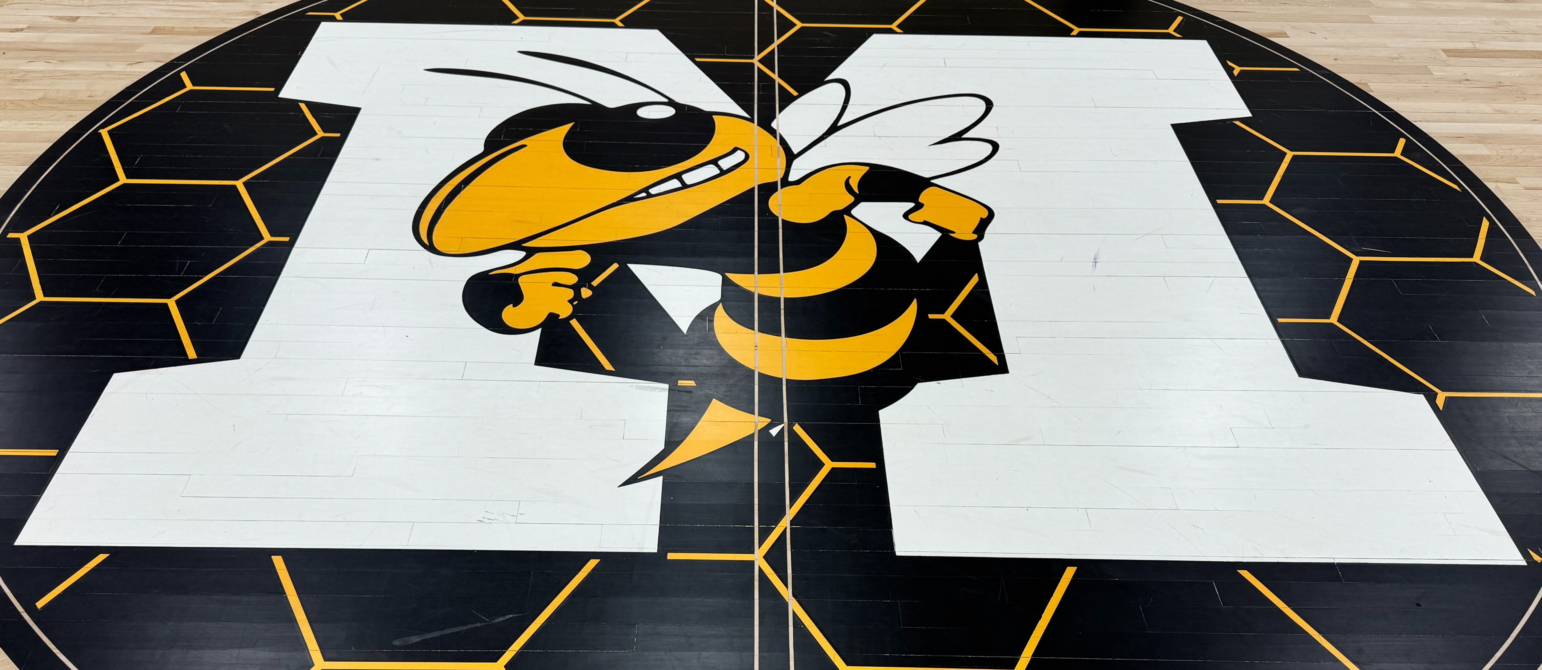 Yellow Jacket logo on gym floor